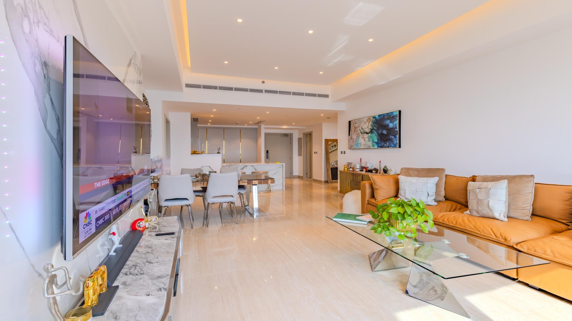 "Luxurious Palm Jumeirah apartment living room with modern decor and panoramic window views.",Fully renovated Palm Jumeirah apartment living room with modern decor and elegant furnishings