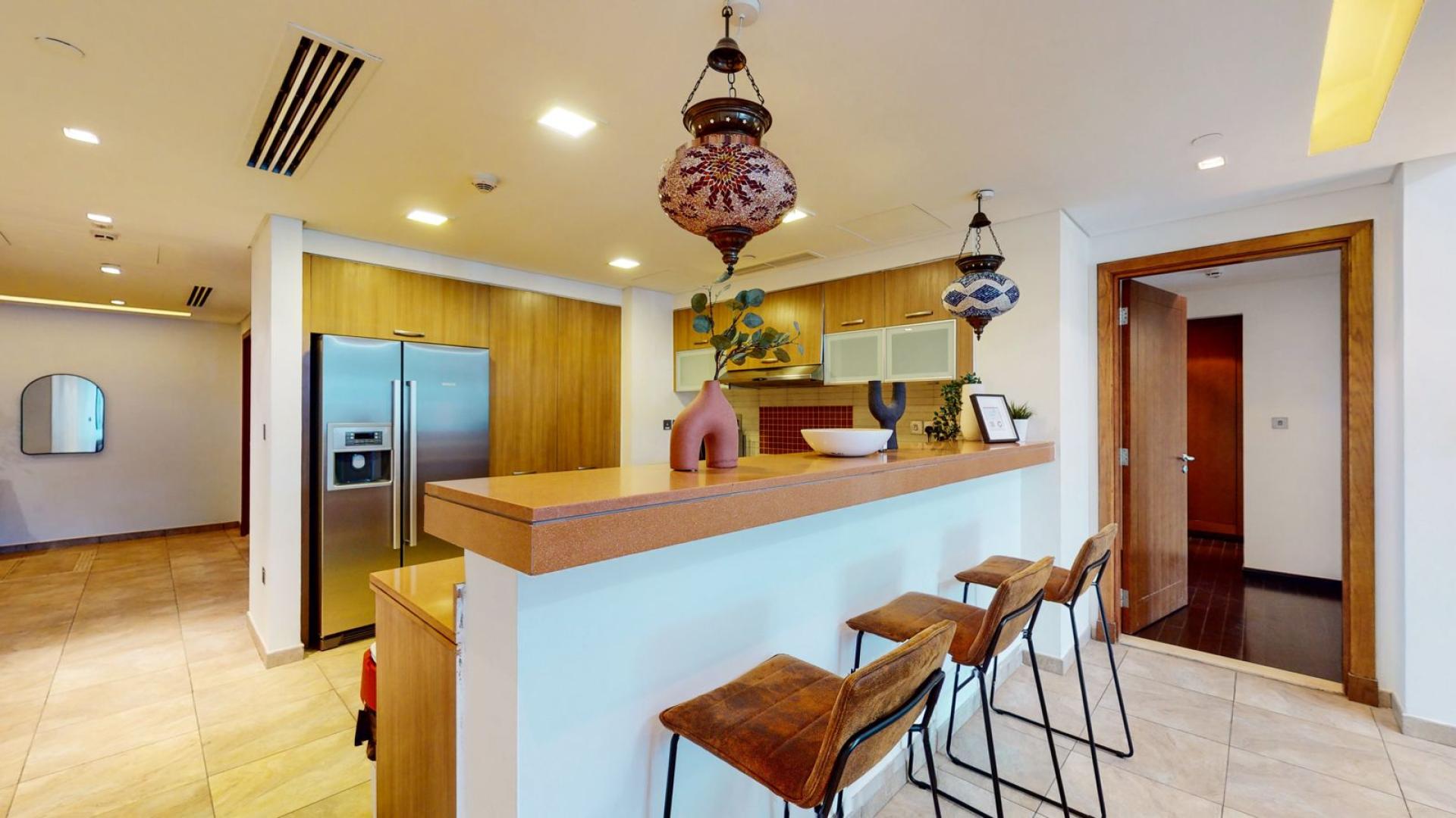 Contemporary living room in Marina Residences apartment, Palm Jumeirah, featuring modern decor and balcony view