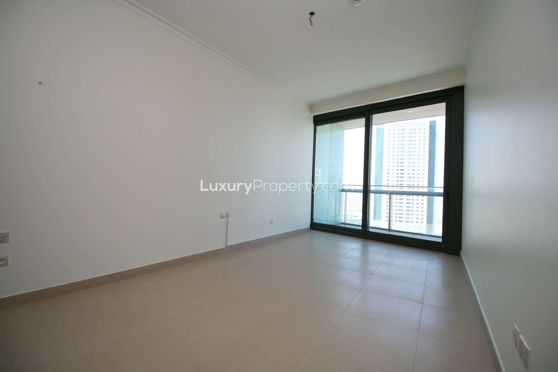 Empty room with large window and Burj Khalifa view in Burj Vista apartment