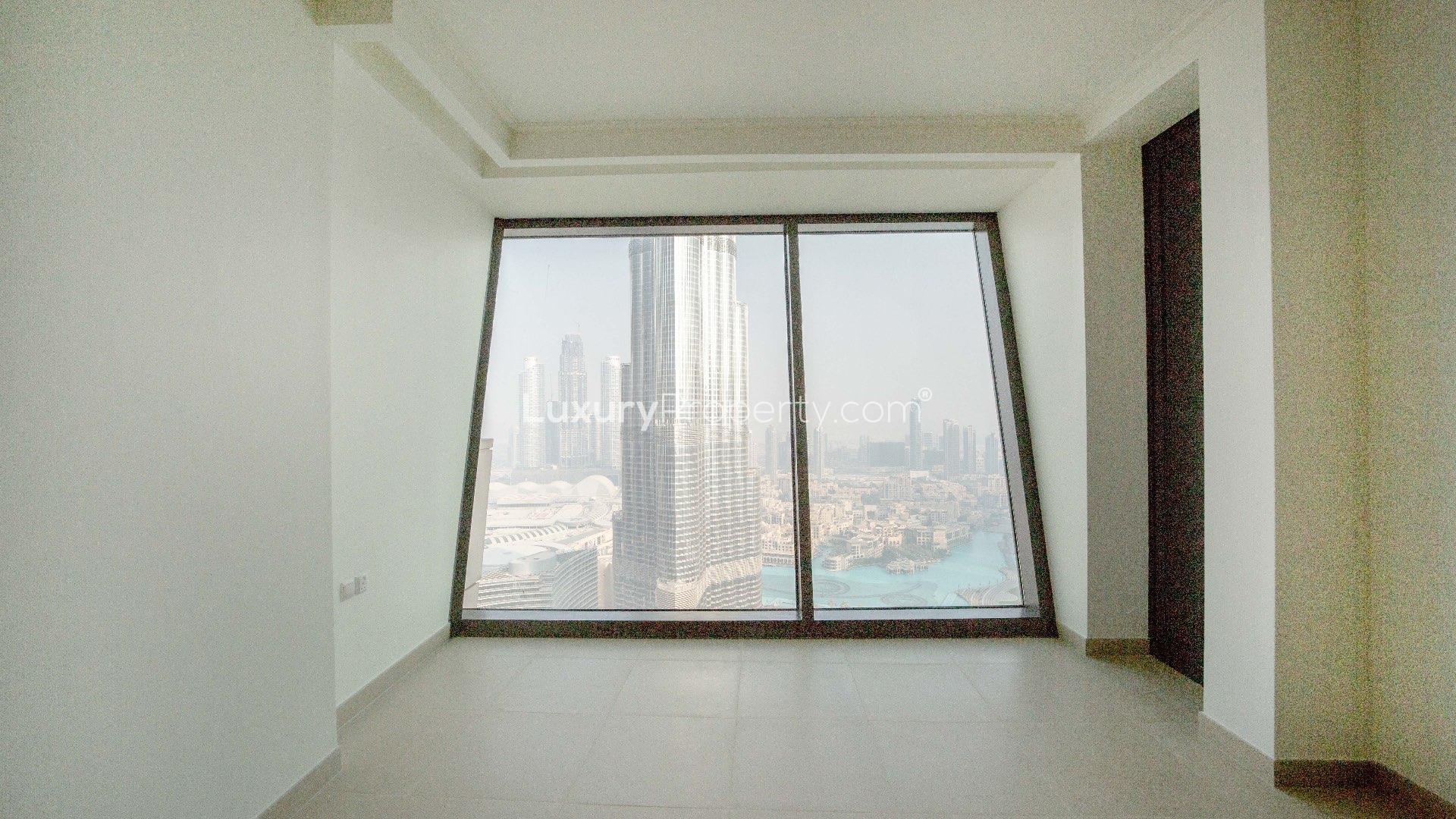 "Bright apartment interior with Burj Khalifa view in Burj Vista, Downtown Dubai.",Skyline view from Burj Vista apartment, showcasing Downtown Dubai and iconic Burj Khalifa