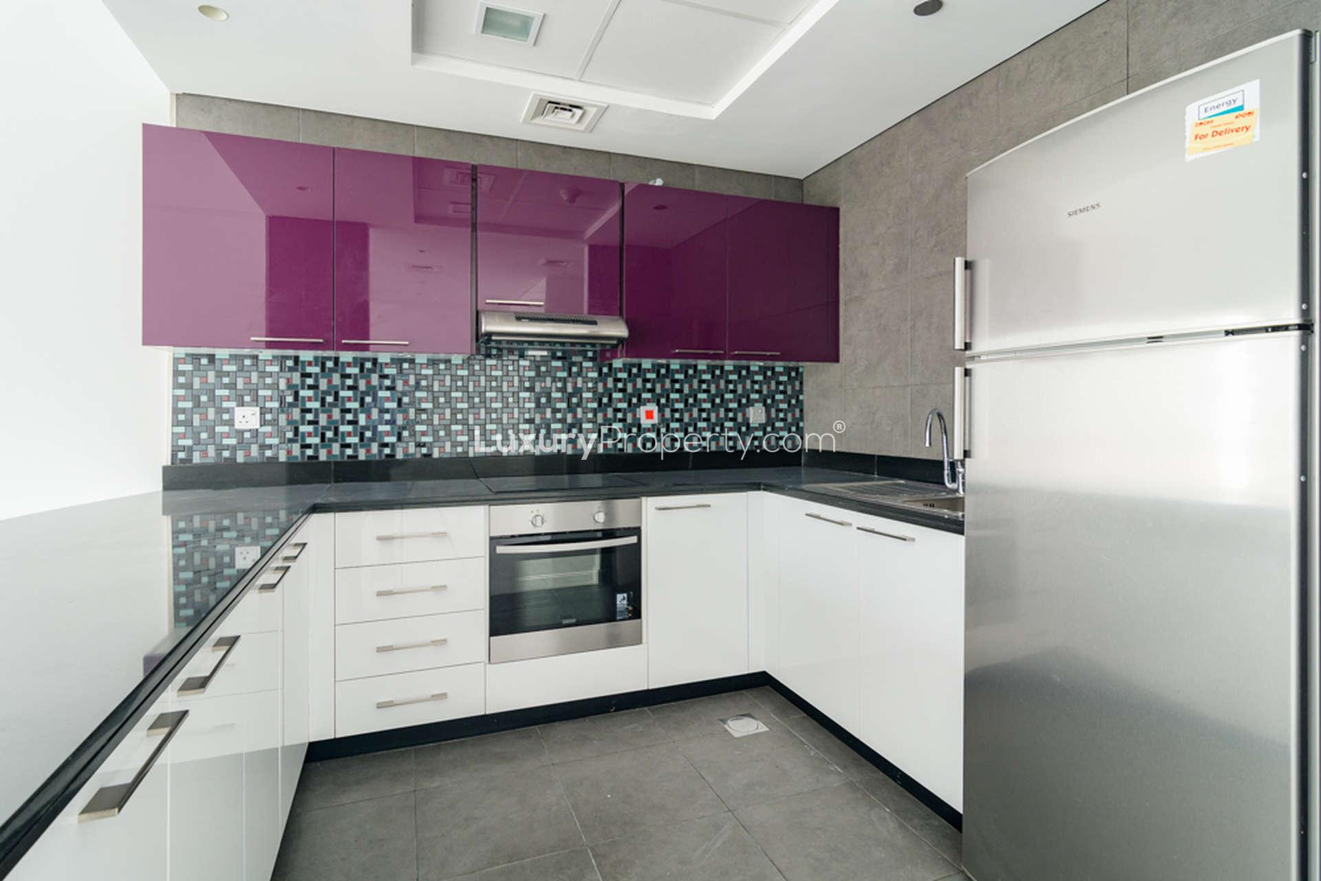 Spacious, bright living area with large windows in Cayan Tower apartment, Dubai Marina