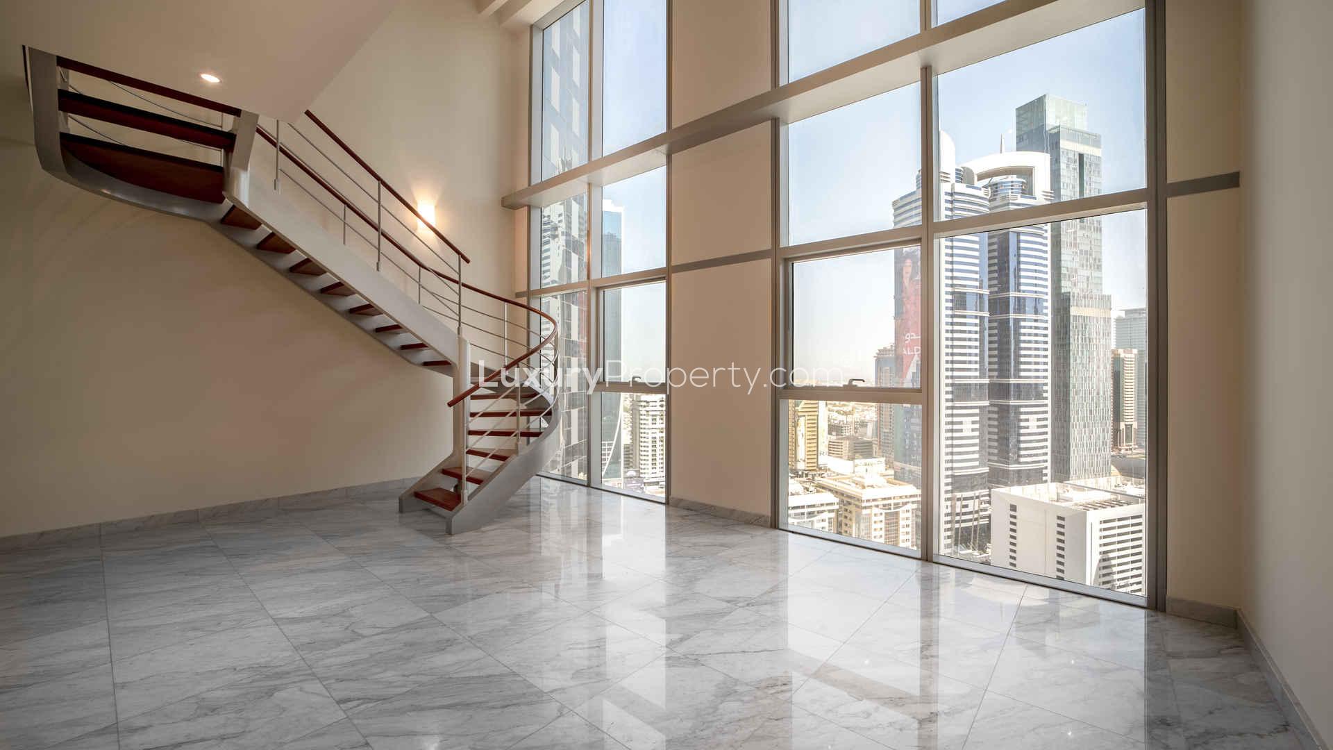 Modern kitchen in 2-bedroom duplex, Central Park Towers, DIFC, featuring wood cabinets and marble floors