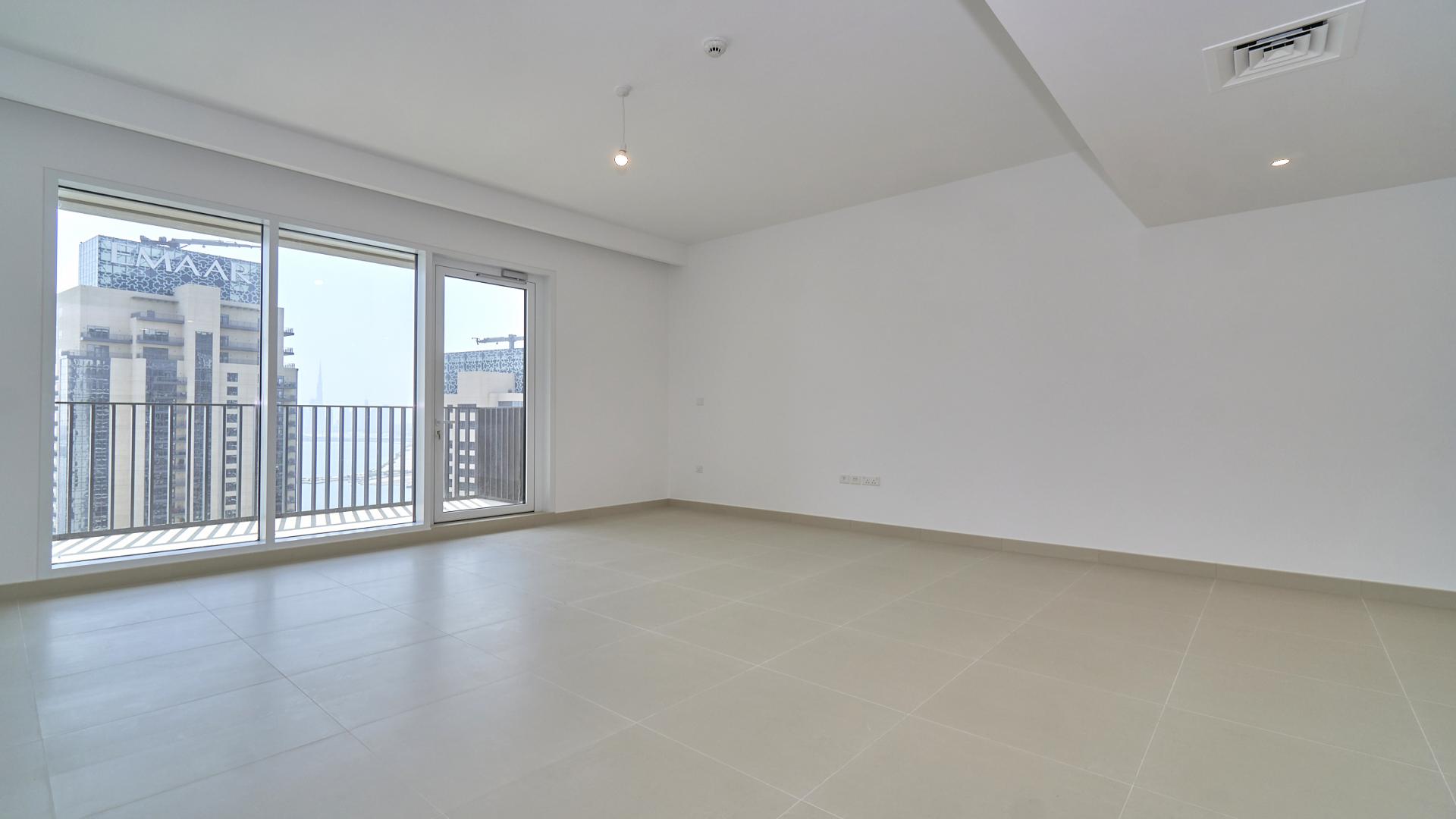 "Balcony view of Dubai Creek Harbour from Creek Horizon apartment for sale, LP12164.",Empty living room with large windows and harbour views in Dubai Creek Harbour apartment