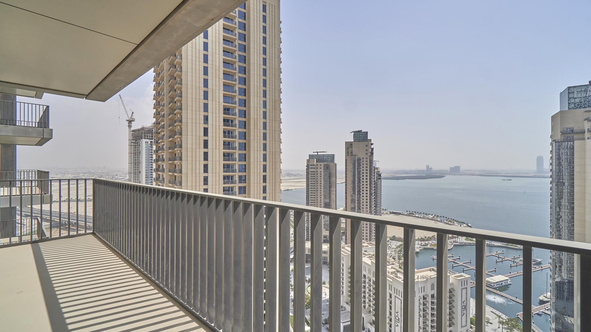 Spacious living area in 2-bedroom apartment, Dubai Creek Harbour, with balcony and harbour views