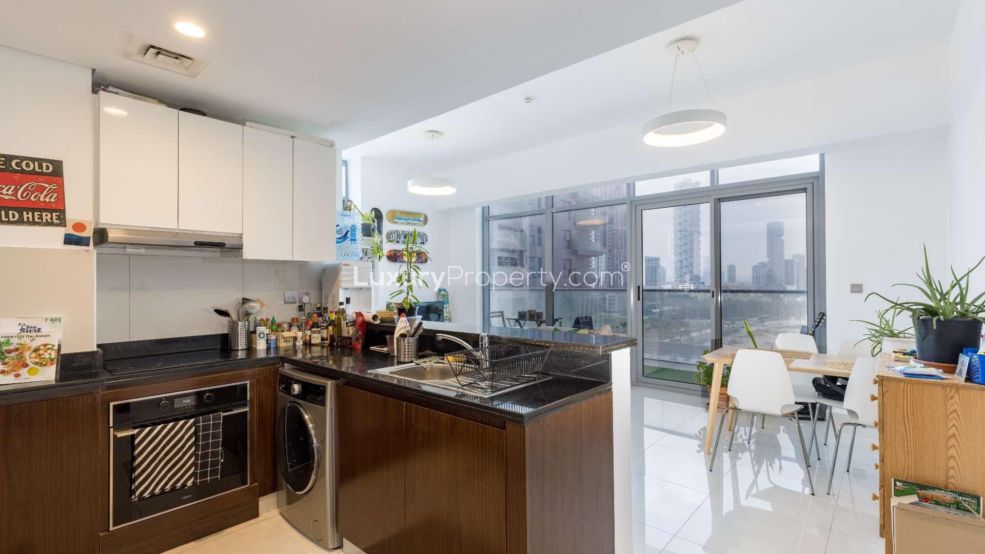 Spacious balcony in JVC apartment, green flooring, outdoor seating, city view, Dezire Residences