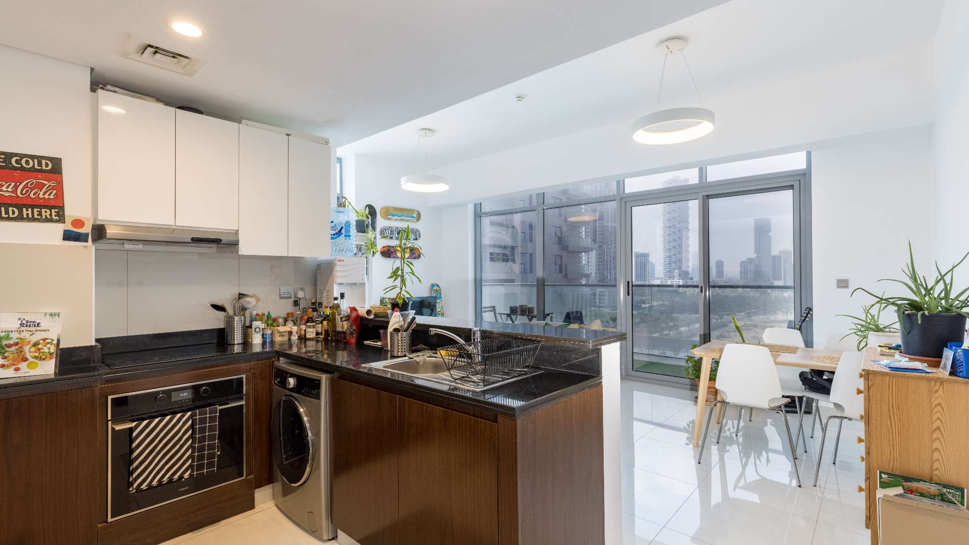 Spacious balcony in JVC apartment, green flooring, outdoor seating, city view, Dezire Residences