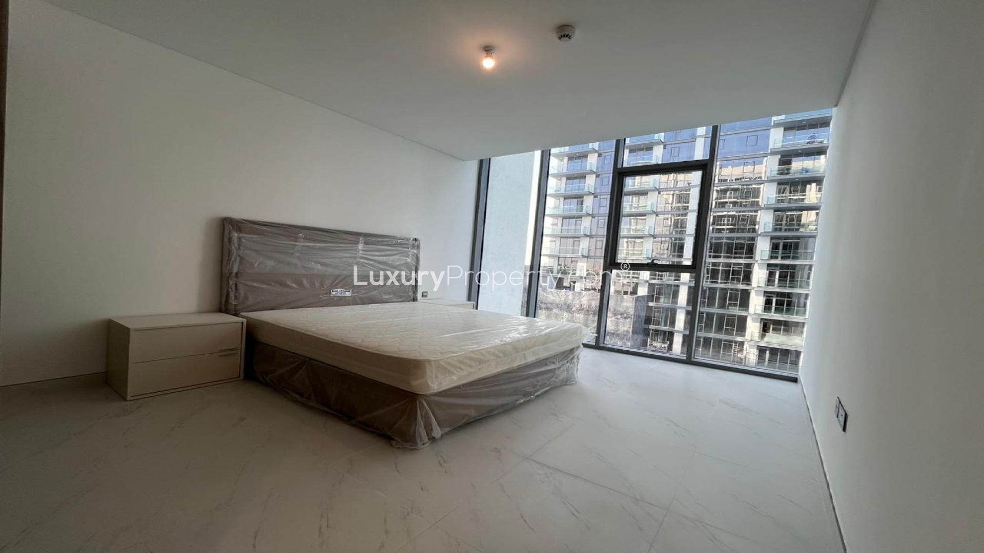 Modern living room in lagoon-facing 2-bedroom apartment, District One, MBR City