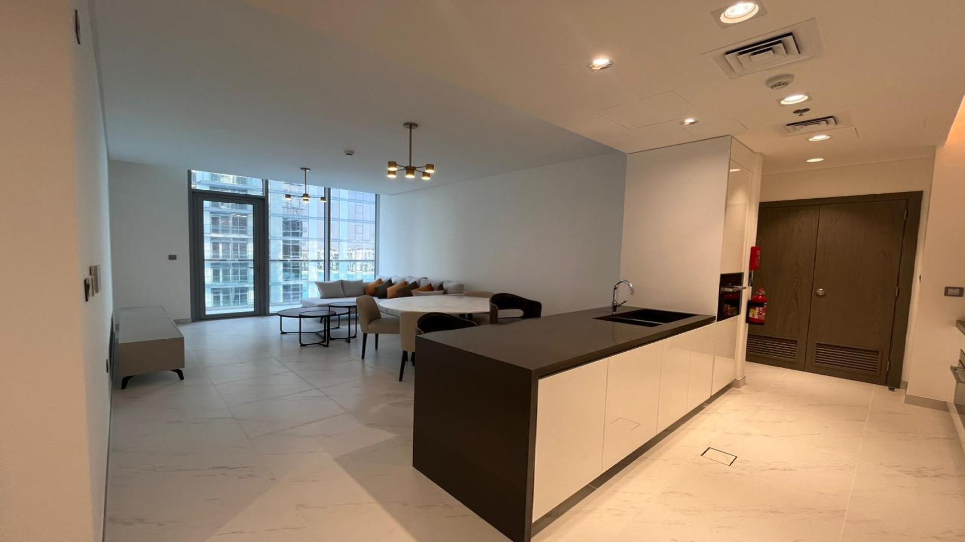 Lagoon facing apartment buildings in MBR City, District One, with skyline view