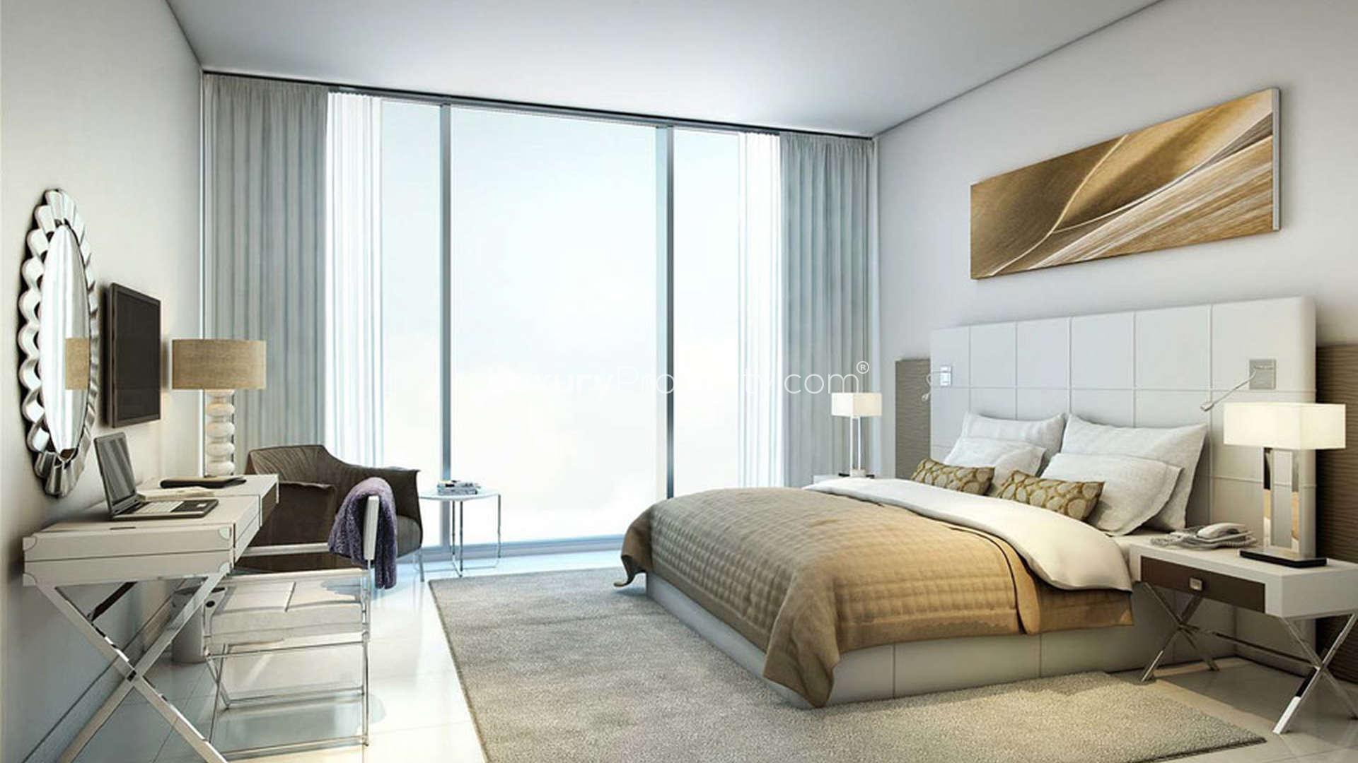 Night view of Dragon Towers entrance with dragon sculpture in Dragon City