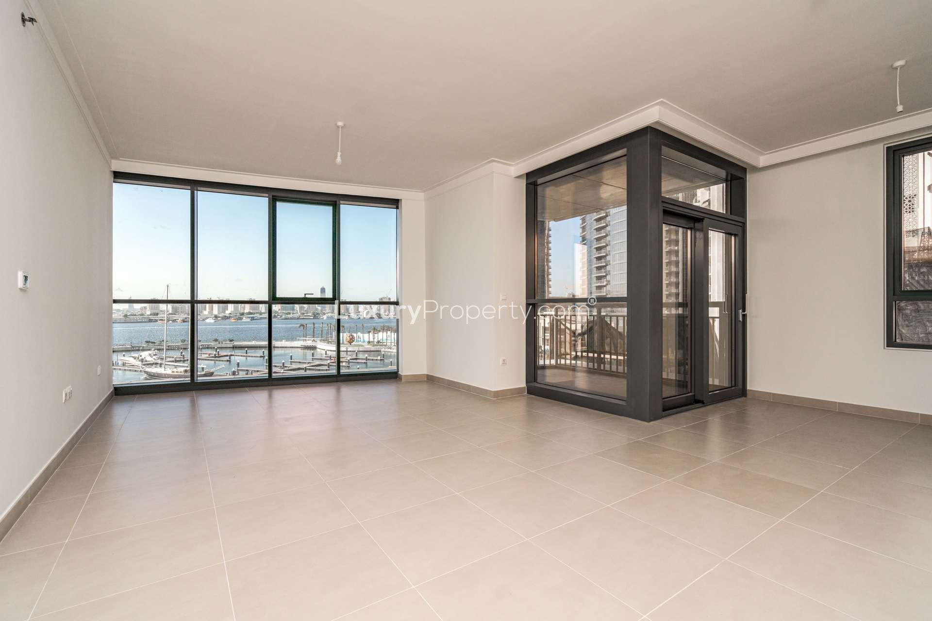 Modern interior of 2-bedroom apartment in Creek Harbour Residences, Dubai, with wooden doors
