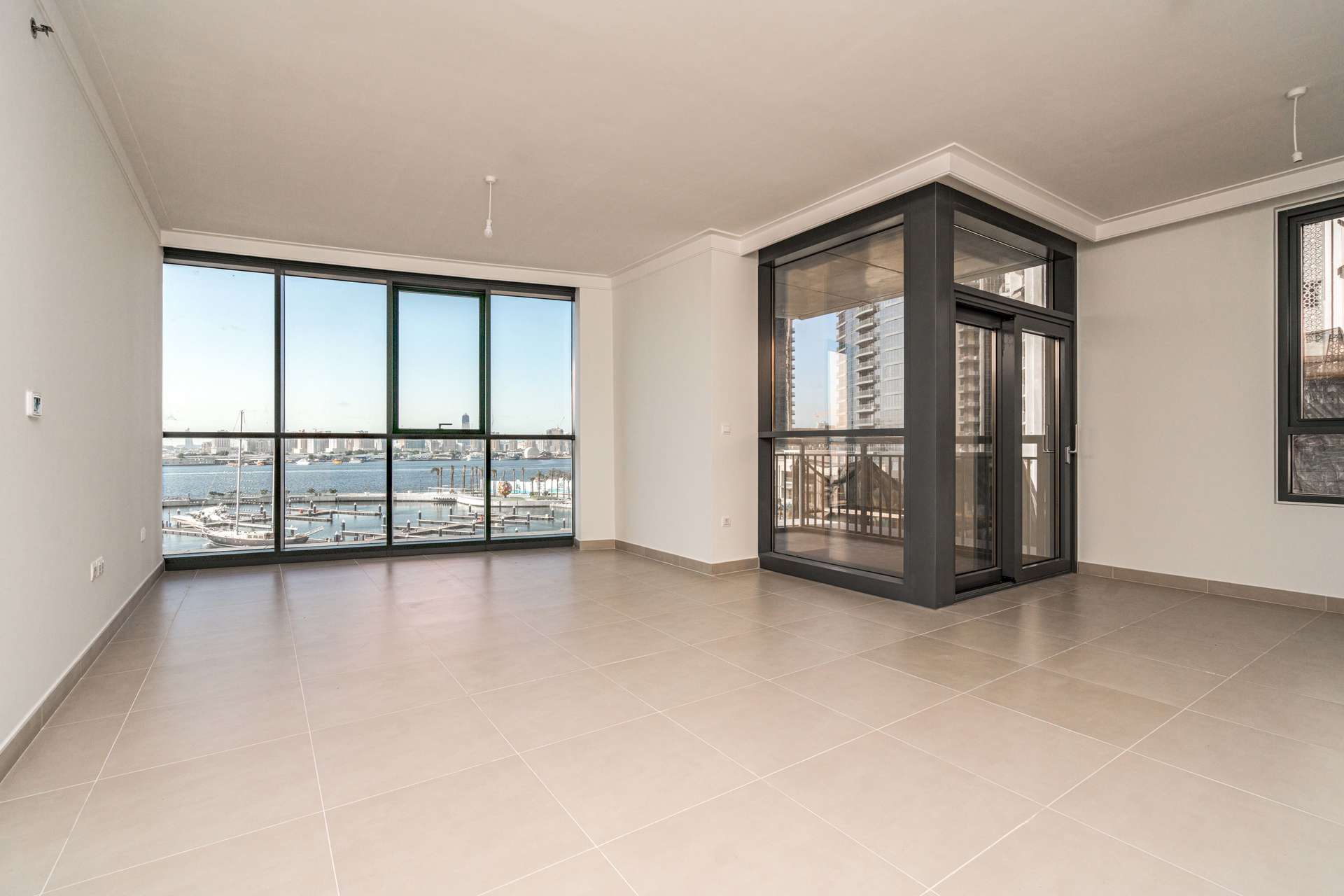Modern interior of 2-bedroom apartment in Creek Harbour Residences, Dubai, with wooden doors