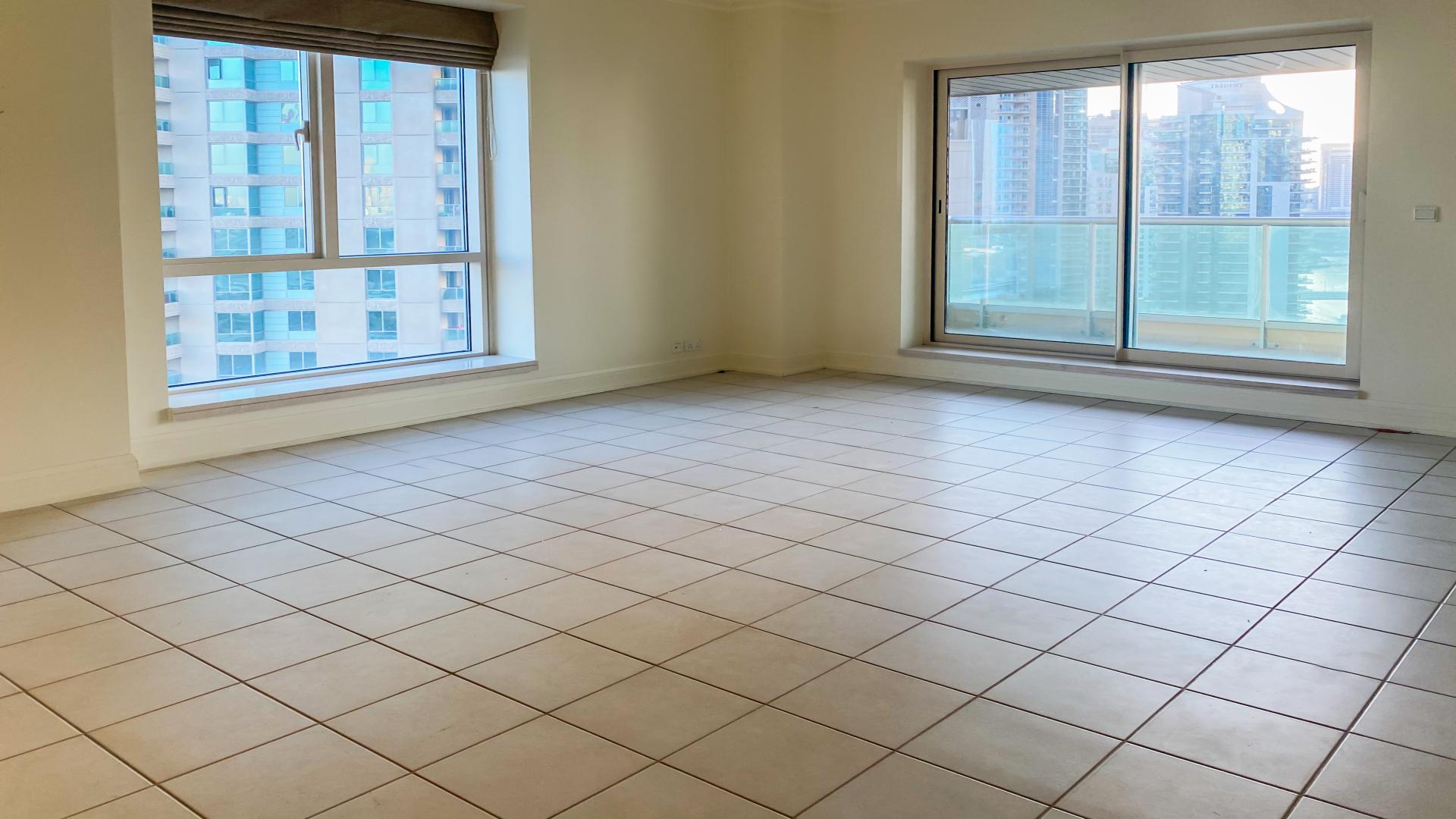 Sunset view of Dubai Marina from Emaar 6 Towers apartment balcony, featuring yachts and skyline