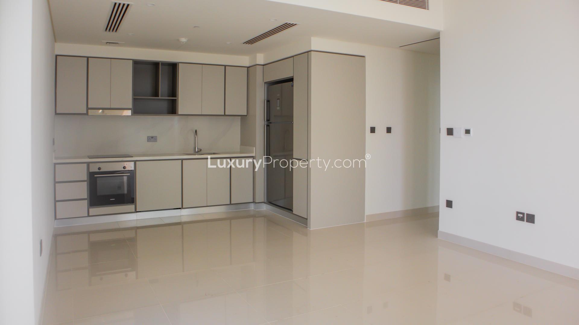 "Stunning sea view from 2-bed apartment balcony, Emaar Beachfront, Dubai Harbour, for sale.",Brand new Dubai Harbour apartment kitchen with modern cabinets and appliances at Emaar Beachfront