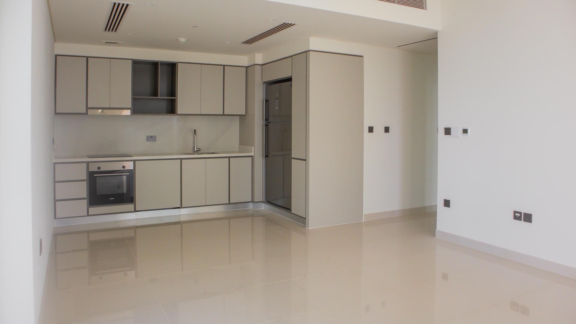 "Stunning sea view from 2-bed apartment balcony, Emaar Beachfront, Dubai Harbour, for sale.",Brand new Dubai Harbour apartment kitchen with modern cabinets and appliances at Emaar Beachfront