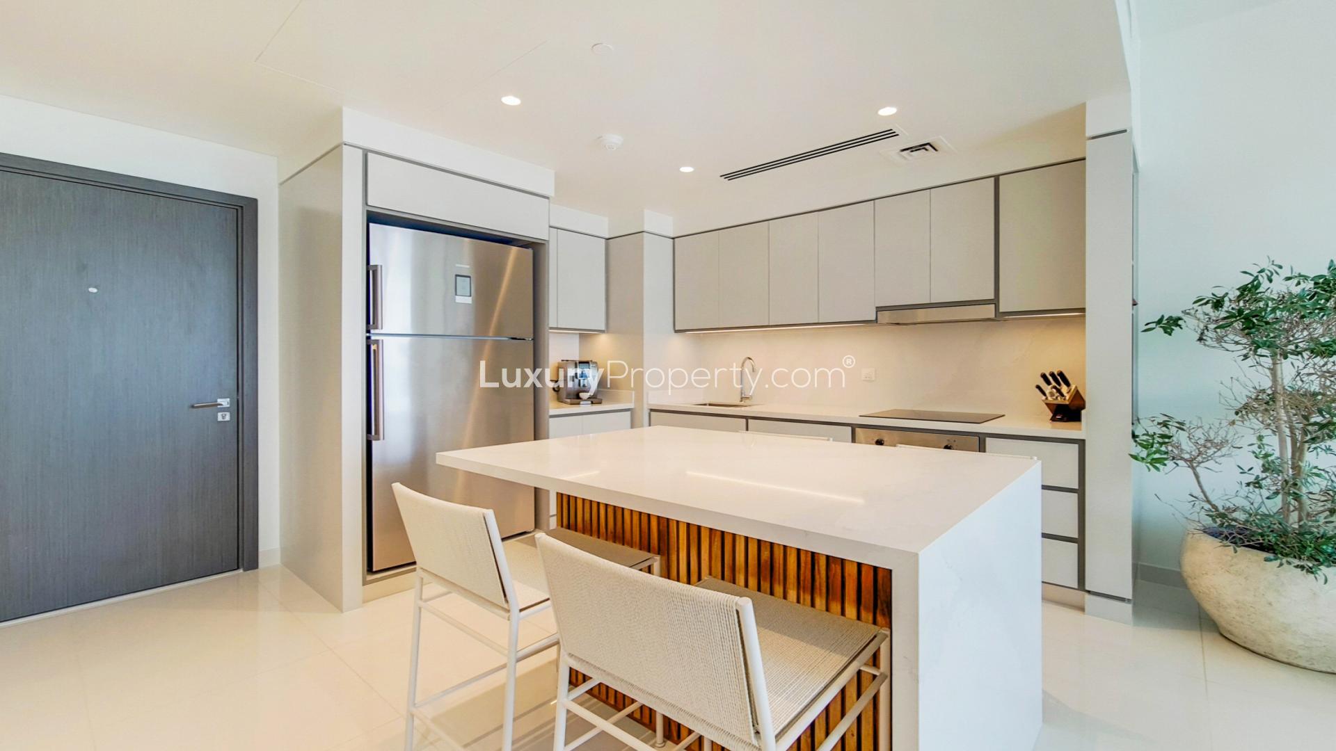 Modern kitchen in Emaar Beachfront penthouse apartment, Dubai Harbour, with sleek cabinetry and island