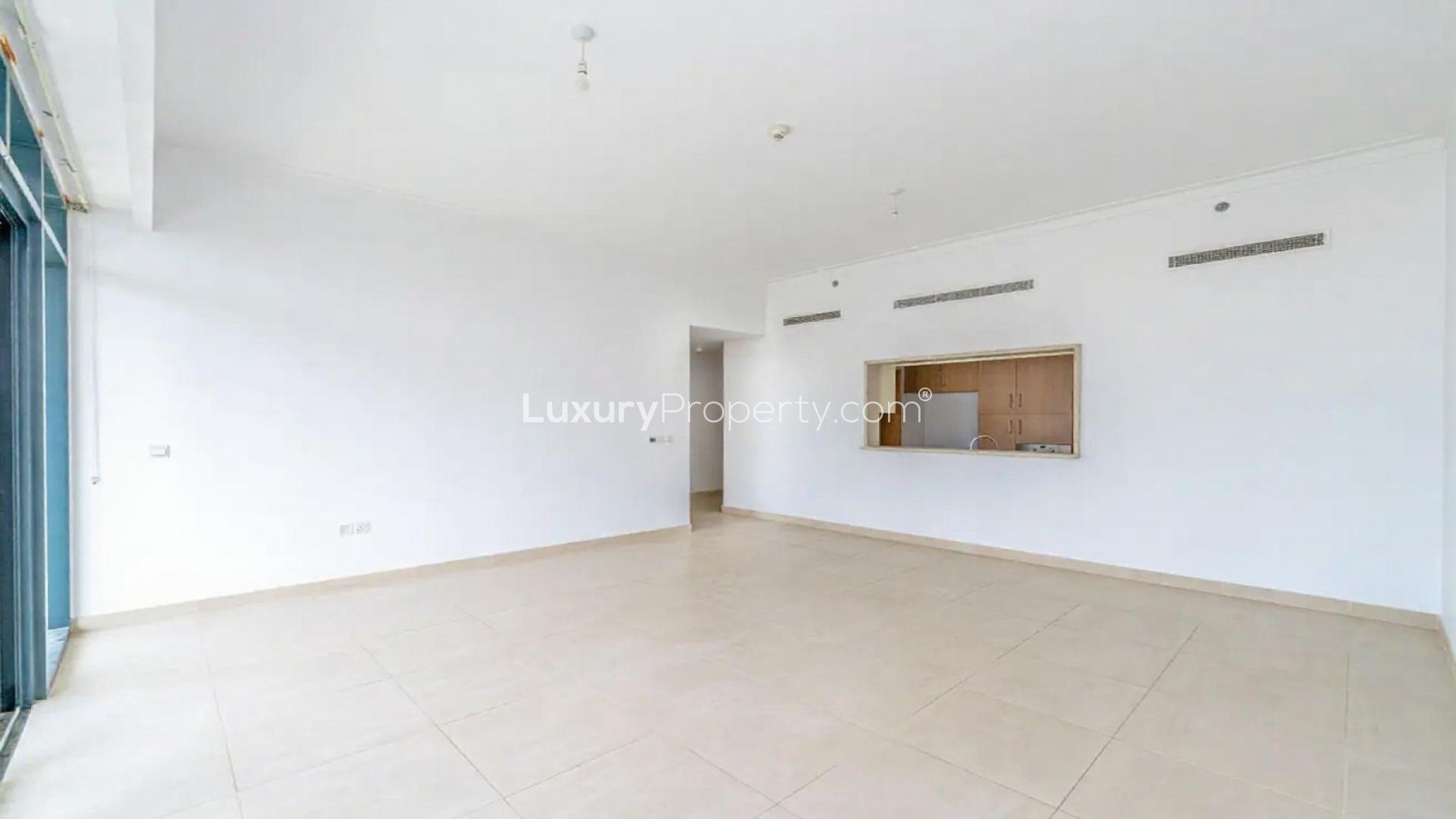 N/A,Empty living area in Vida Residences The Hills apartment, Dubai, with tiled flooring