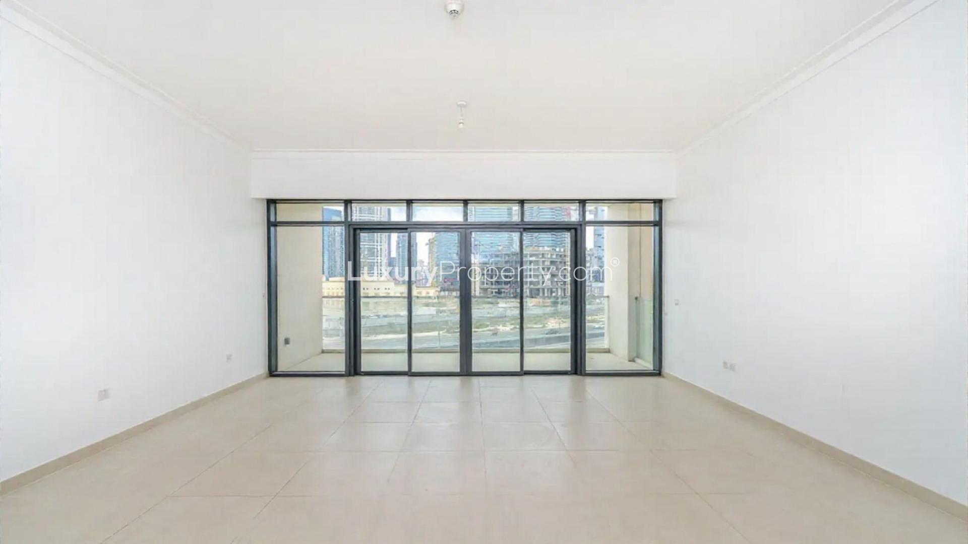 Contemporary open-plan living room with large windows at Vida Residences, The Hills, Dubai