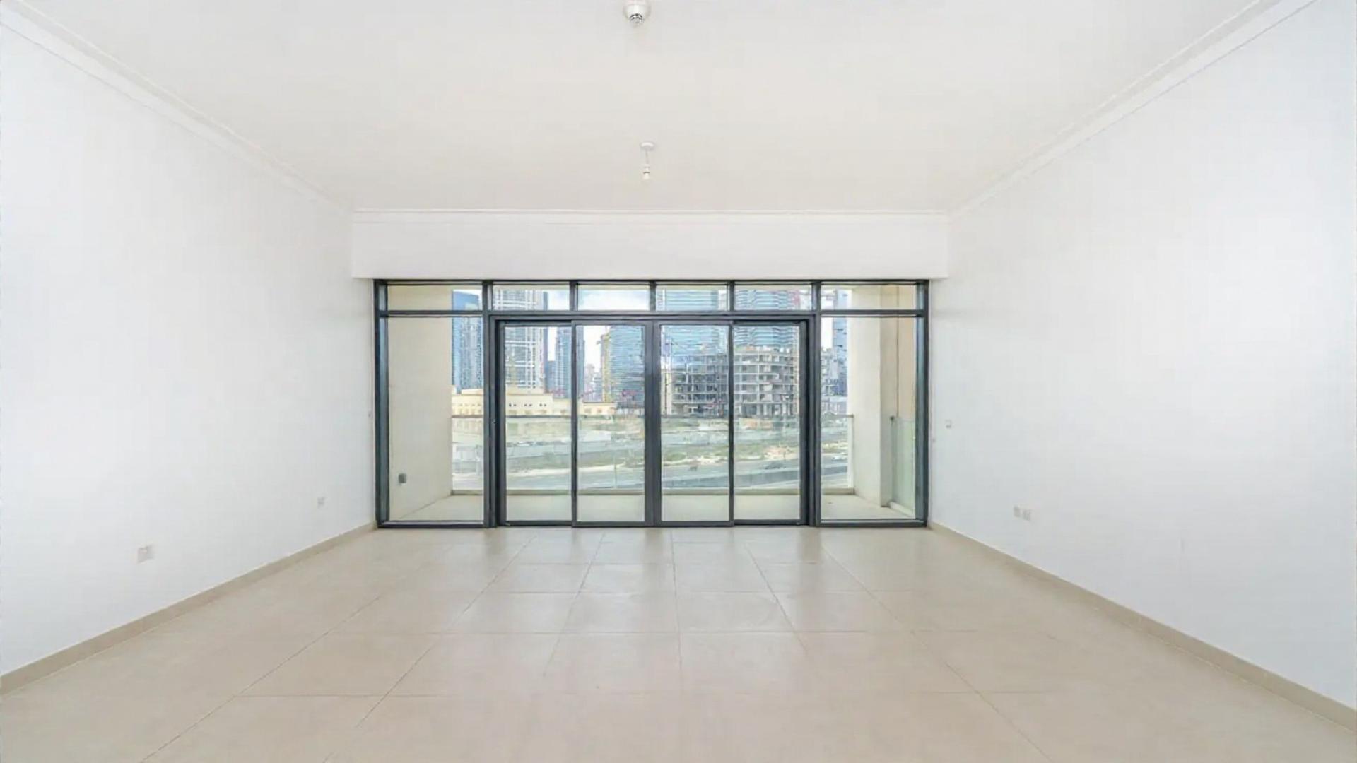 Contemporary open-plan living room with large windows at Vida Residences, The Hills, Dubai