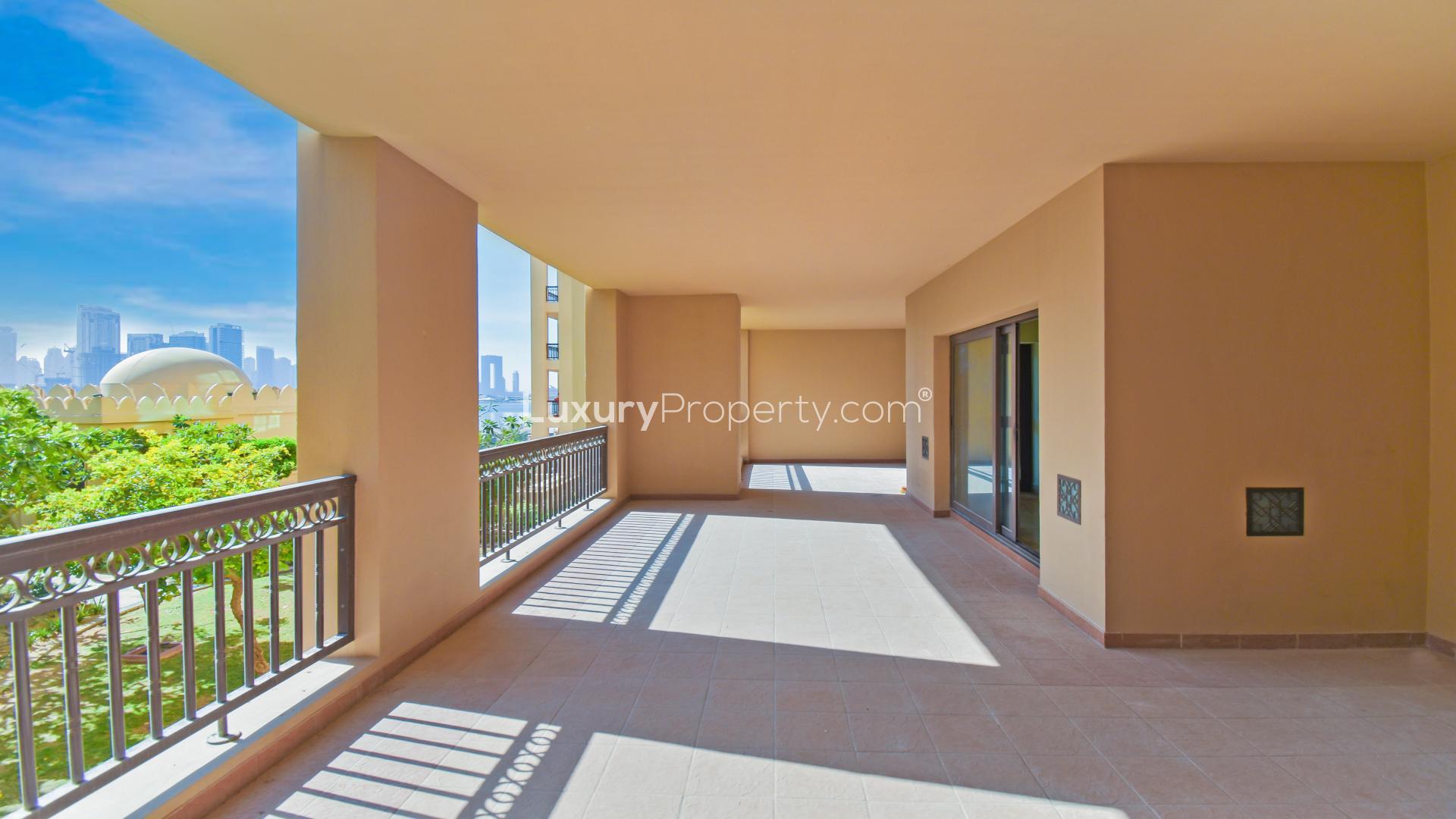 Palm Jumeirah apartment balcony with lush garden and stunning marina skyline views
