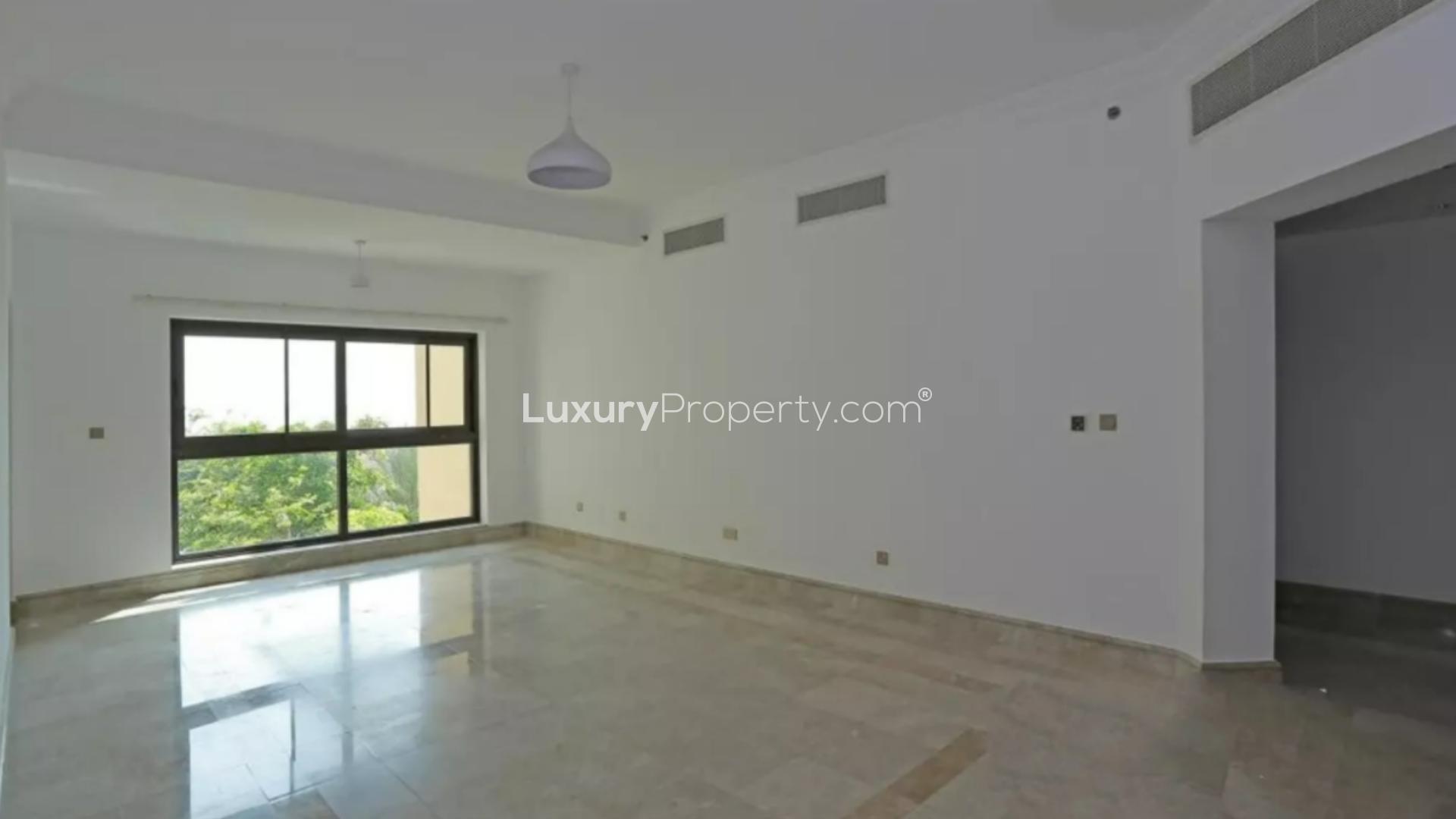 Spacious living room with large window in Palm Jumeirah apartment for sale