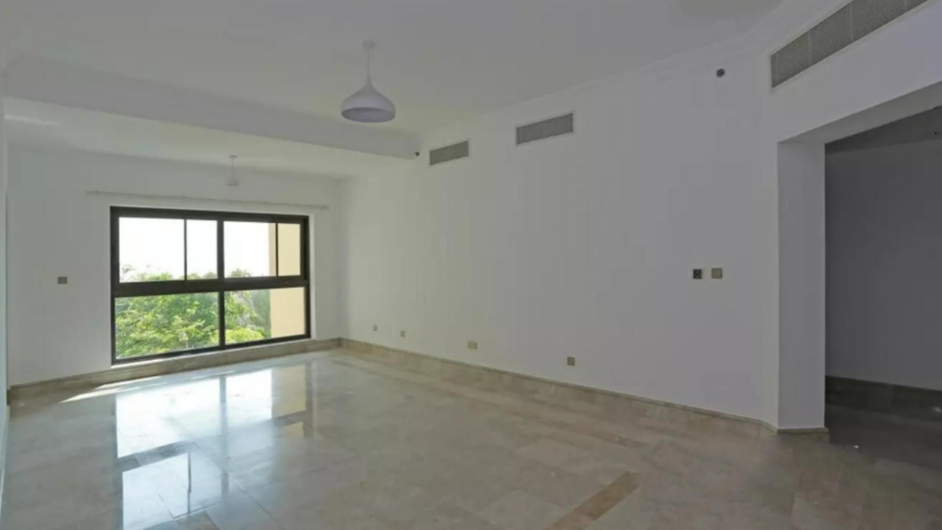 Spacious living room with large window in Palm Jumeirah apartment for sale