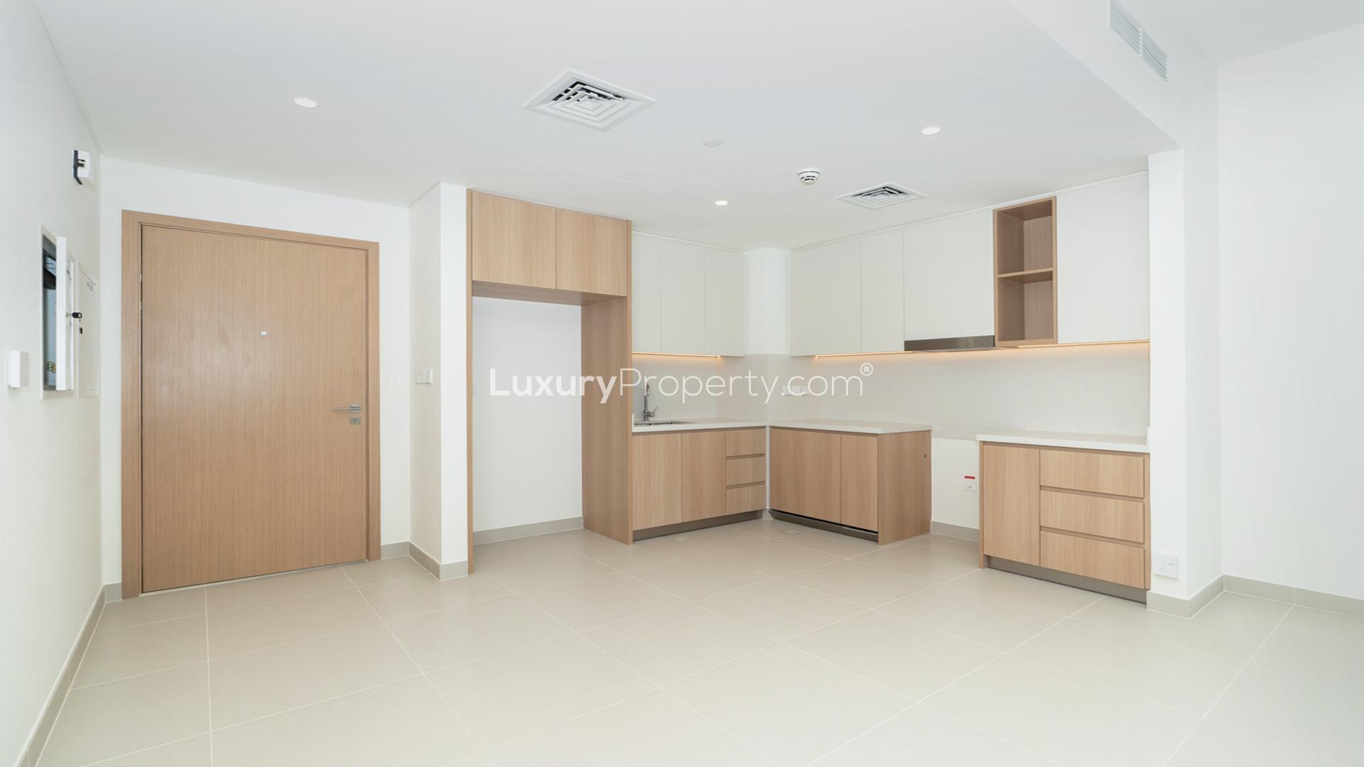 Modern kitchen in Dubai Creek Harbour apartment, Island Park 1, with sleek wooden cabinetry