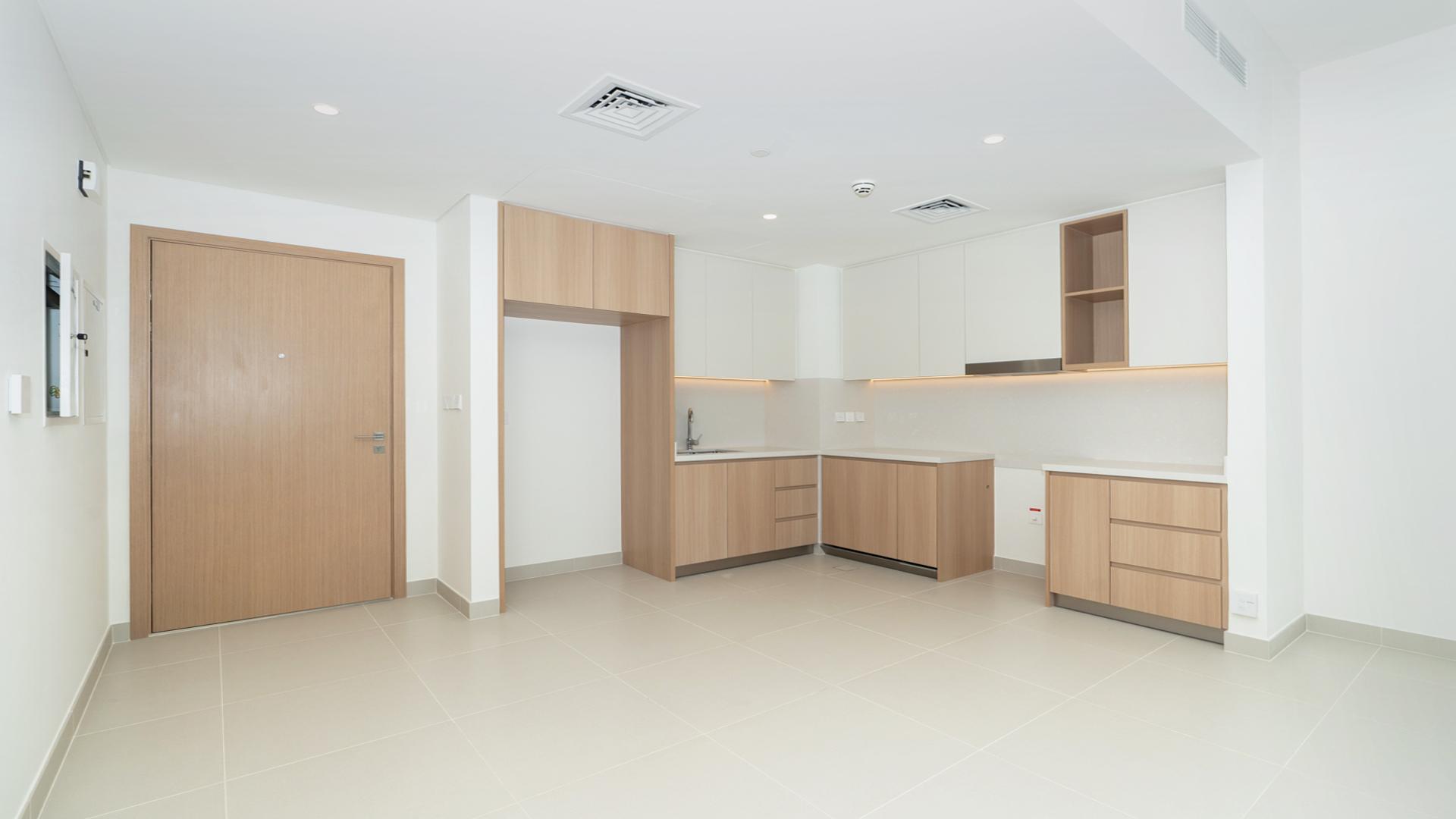Modern kitchen in Dubai Creek Harbour apartment, Island Park 1, with sleek wooden cabinetry