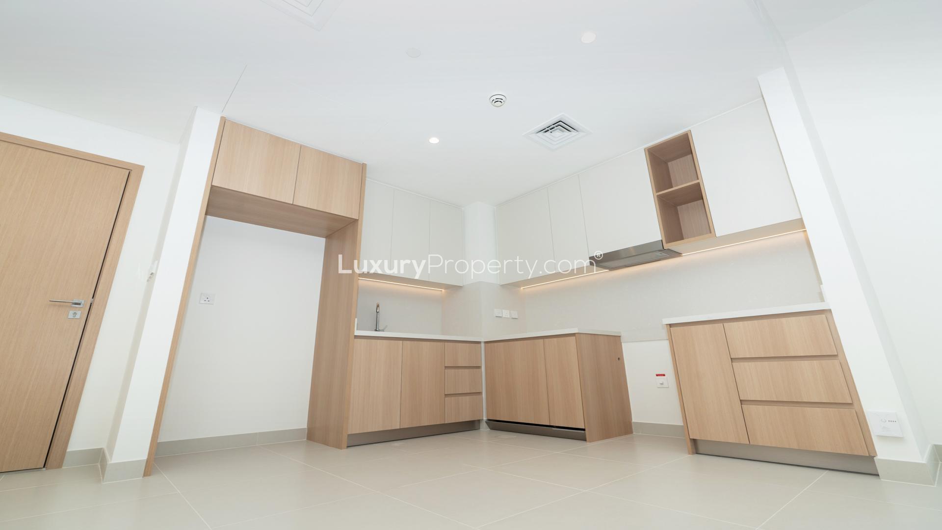 Open-plan kitchen and living area in Dubai Creek Harbour apartment for sale