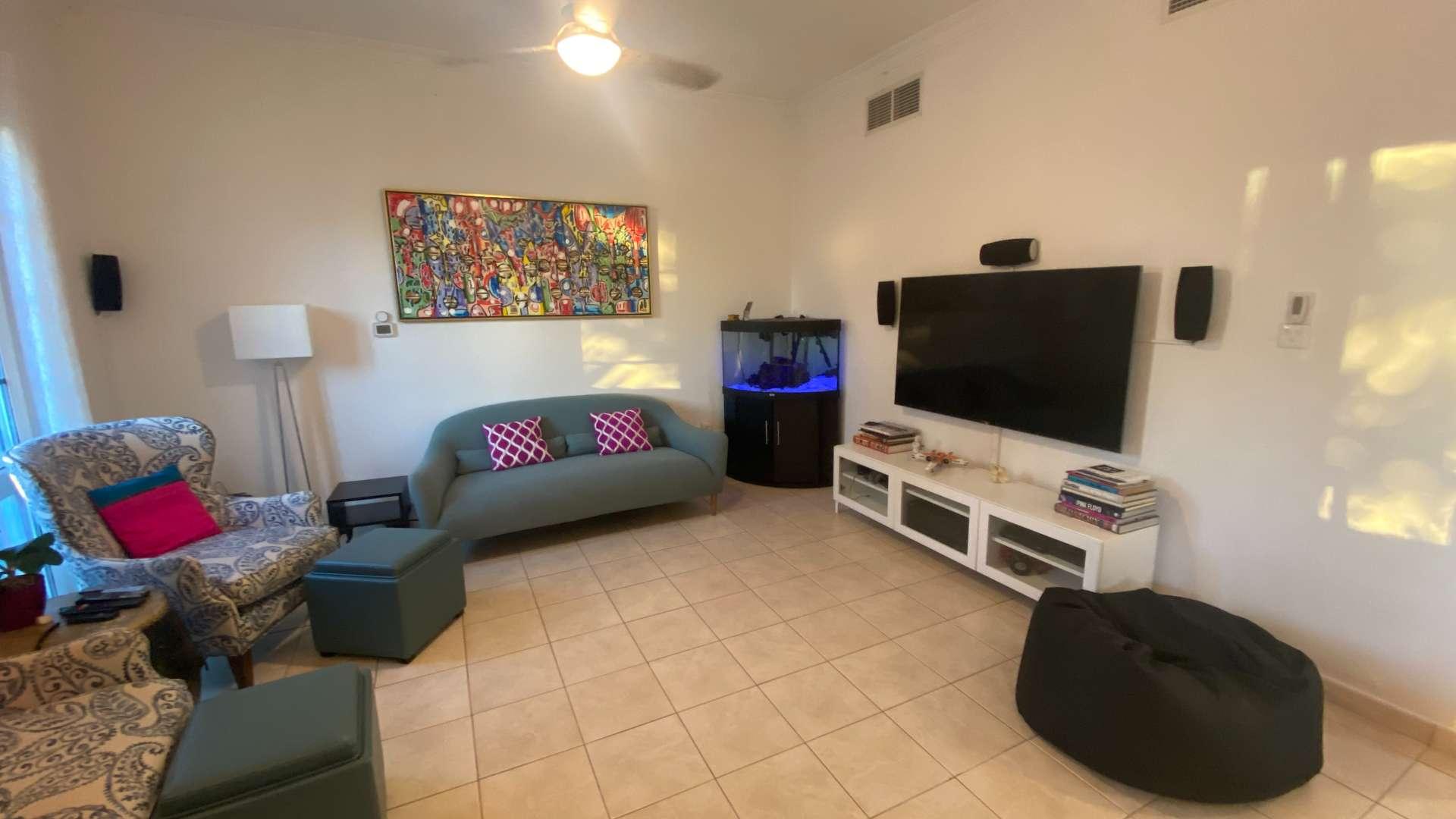 Upgraded Green Community apartment view with pool and palm trees at Garden West Apartments