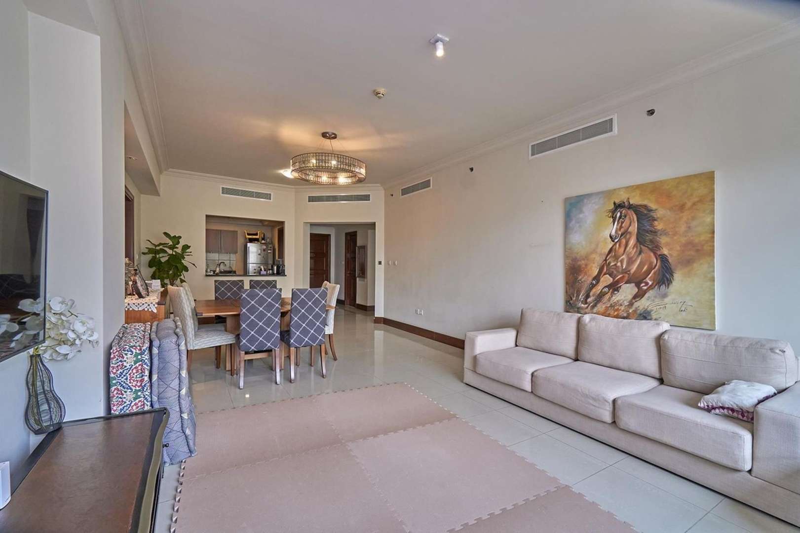 Spacious living room in Palm Jumeirah apartment, featuring elegant decor and modern furnishings