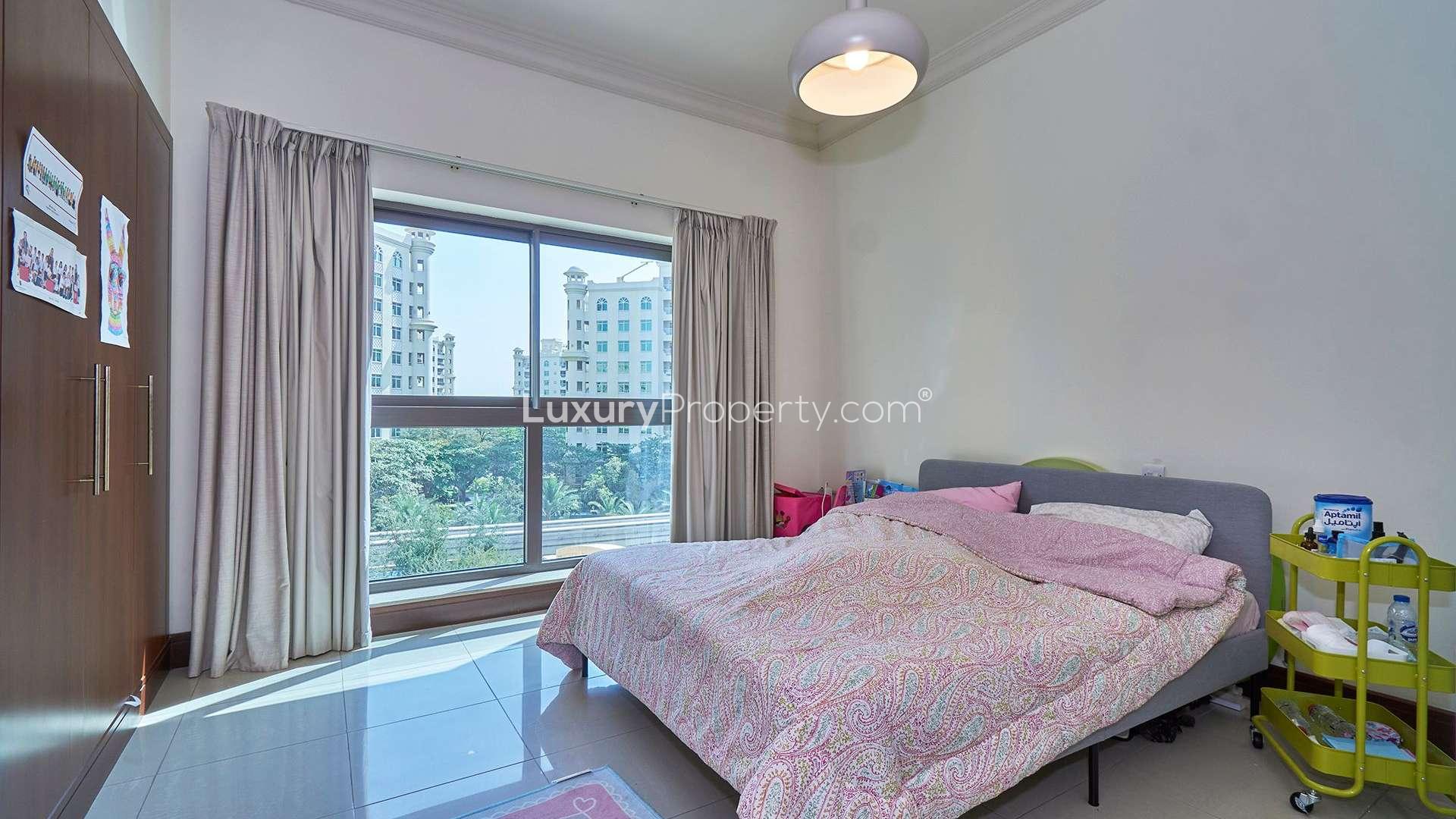 Bright bedroom in spacious Golden Mile apartment, Palm Jumeirah, featuring large window views
