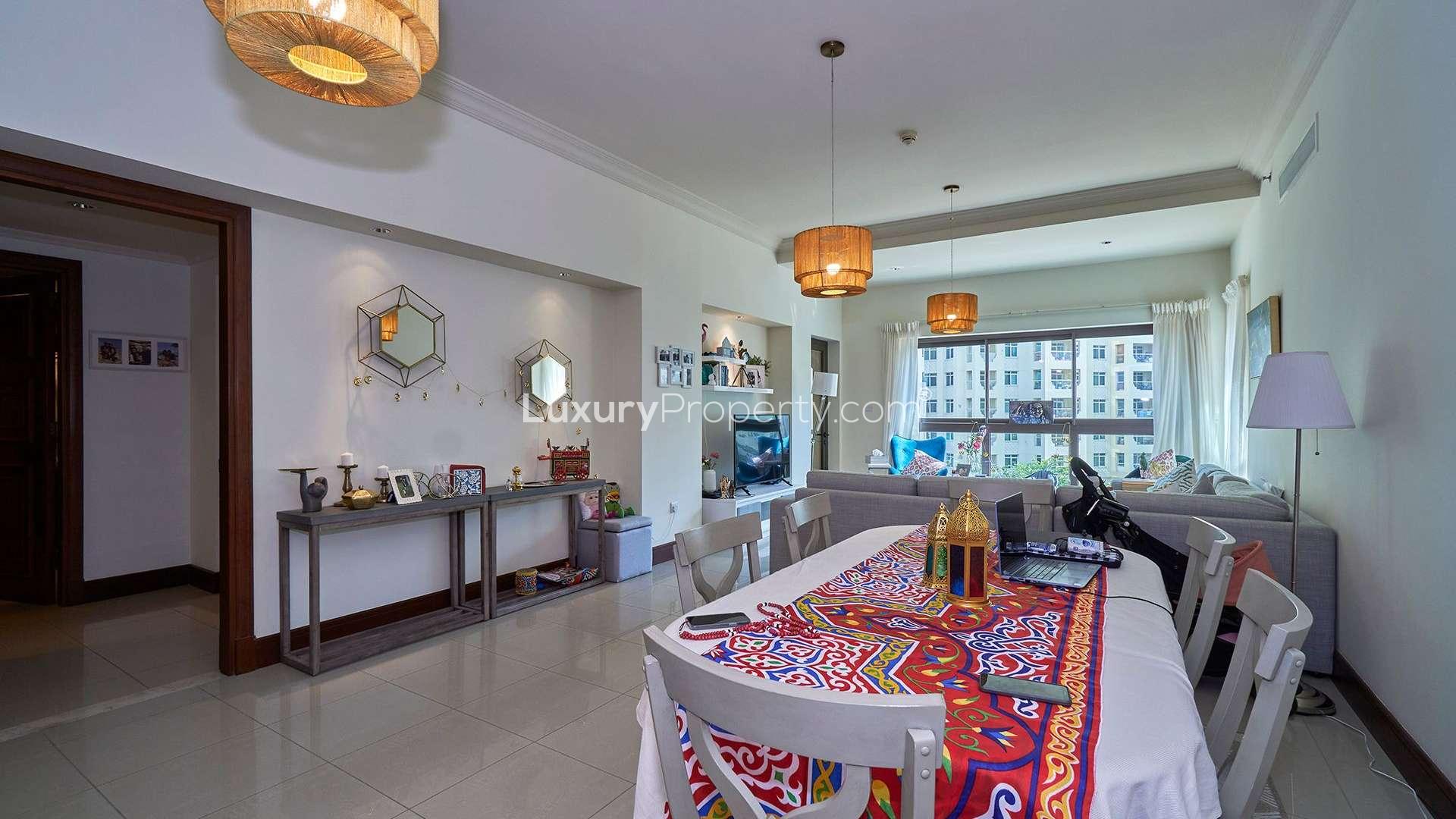 "Golden Mile apartment view, Palm Jumeirah, showcasing residential buildings and lush greenery.",Living room and dining area in spacious Palm Jumeirah apartment, Golden Mile, for sale