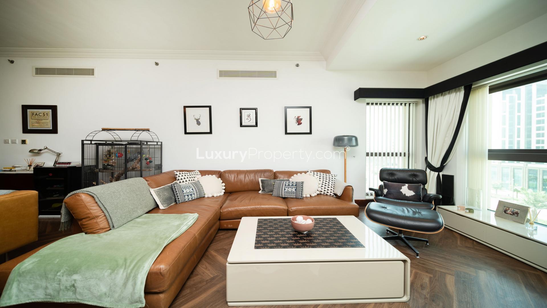 "Spacious balcony with cozy seating in upgraded Golden Mile apartment, Palm Jumeirah for sale.",Luxurious living room in upgraded Palm Jumeirah apartment for sale, Golden Mile community