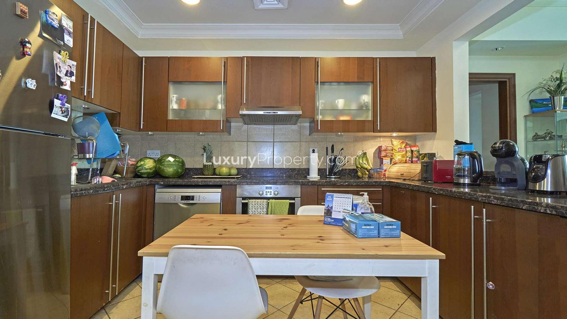 High floor Palm Jumeirah apartment dining area with large window and city view