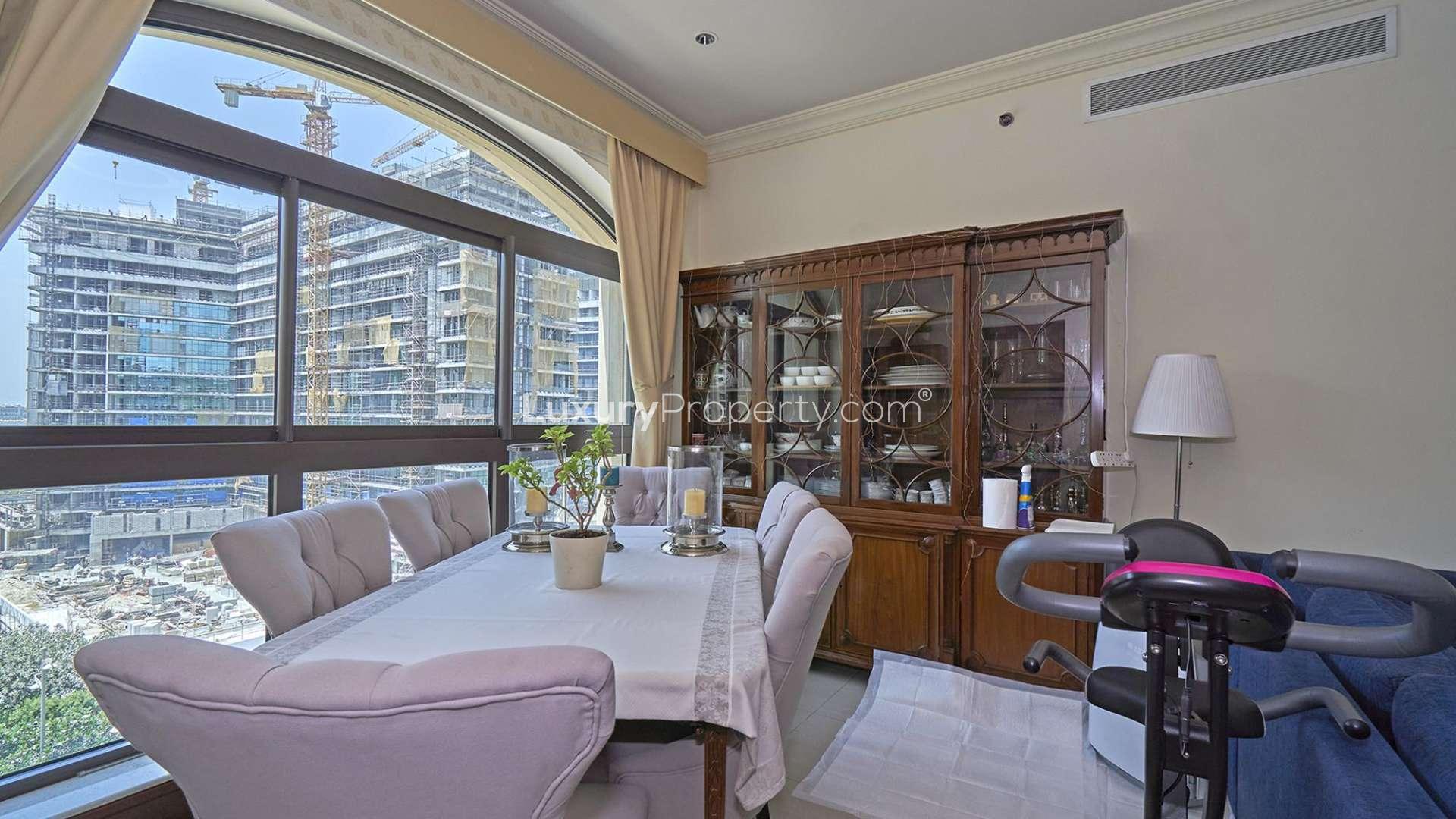 High-floor Palm Jumeirah apartment living room with blue sofa and large window view