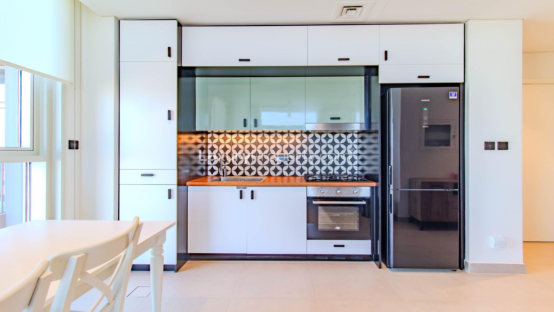 Modern living room and kitchen in Dubai Hills Estate apartment, Collective 2.0, for sale