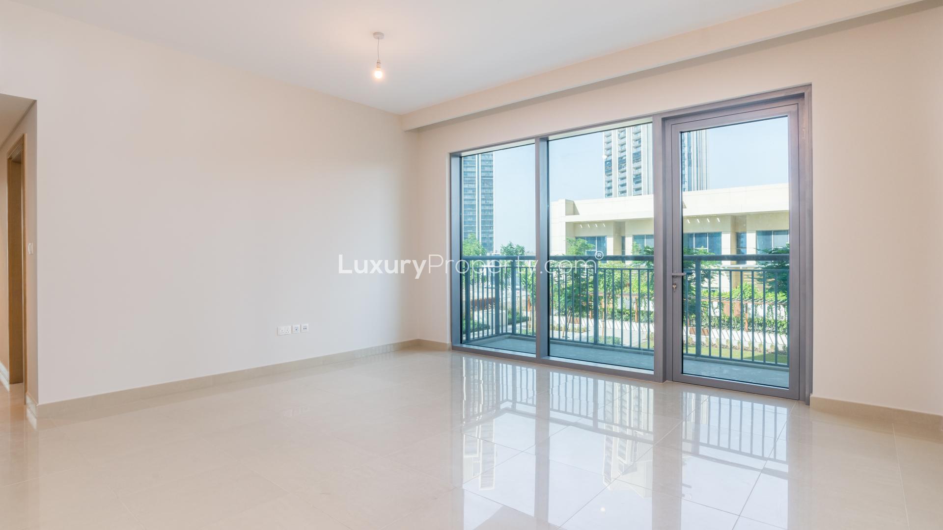 Spacious apartment interior with balcony view of lush greenery in Harbour Views 2, Dubai