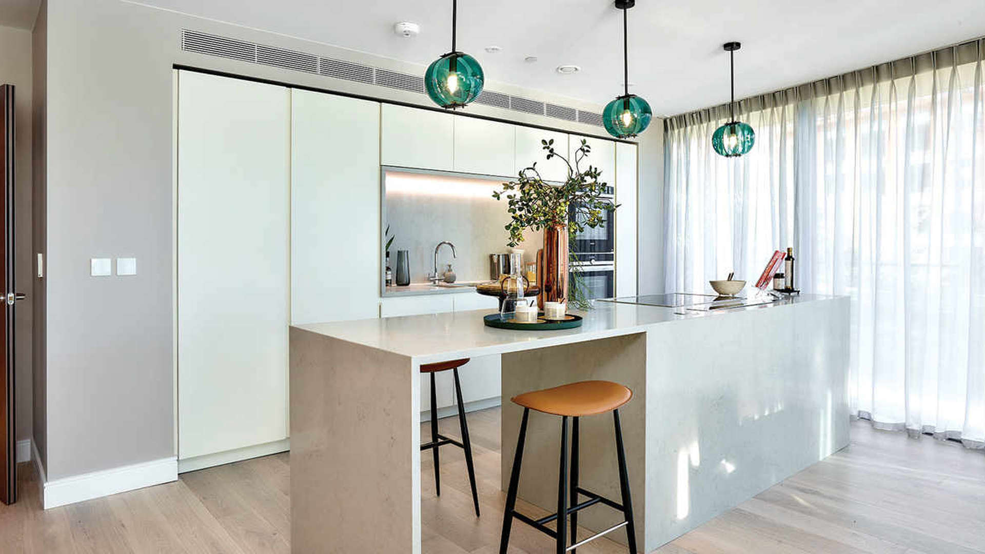 Beautifully designed open-plan kitchen and dining area in Henley Apartments, Fulham Reach, London
