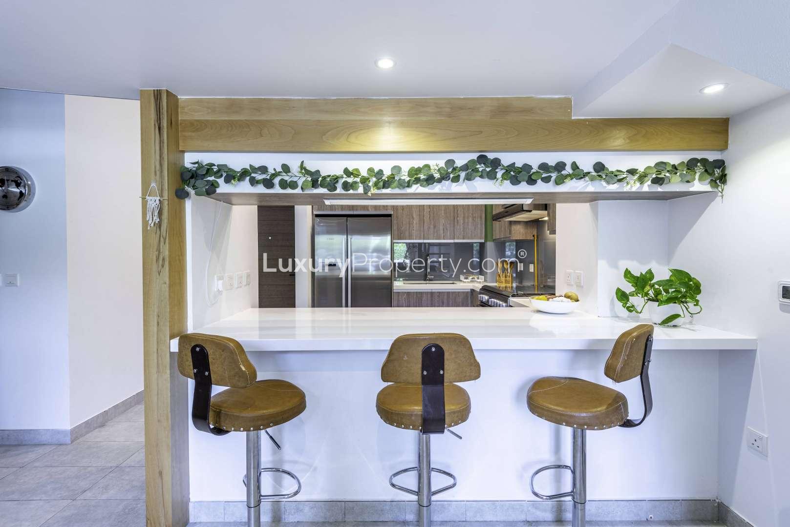 Outdoor seating area in Hyati Residence apartment, Jumeirah Village Circle, with garden view