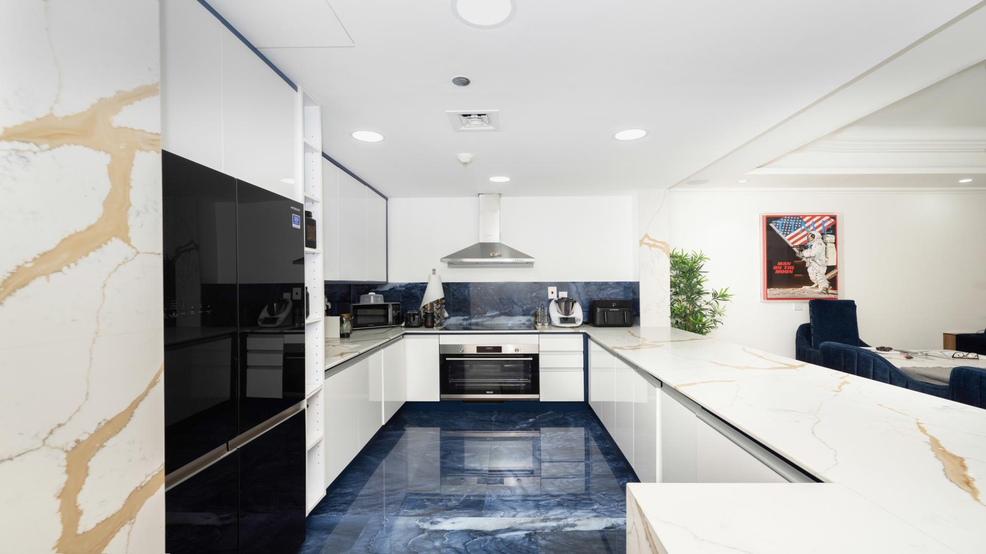 Modern kitchen in Palm Jumeirah apartment, sleek design with marble countertops and high-end appliances