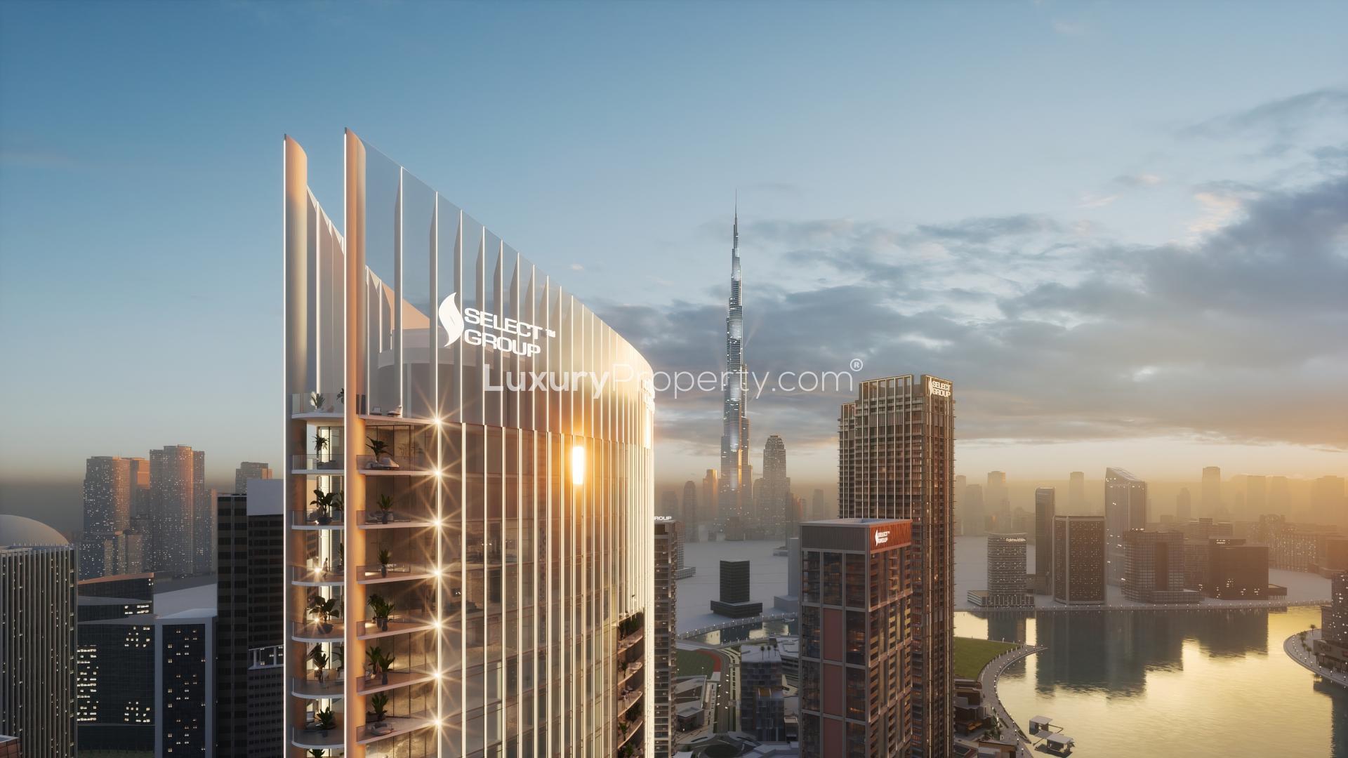 Stunning waterfront view of Jumeirah Living Business Bay apartment building at sunset