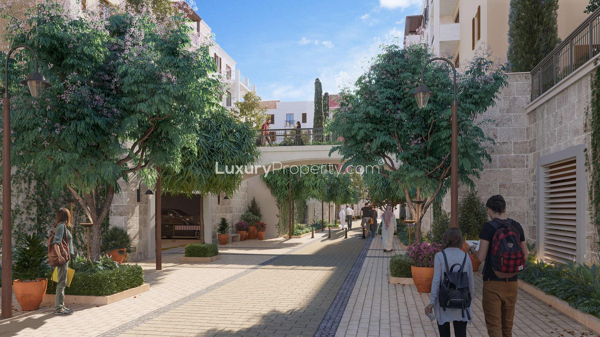 Alt text: "Modern La Rive apartment exterior with marina view in Port De La Mer, Jumeirah.",Outdoor pool area at La Rive apartment, Port De La Mer, Jumeirah, with loungers and trees