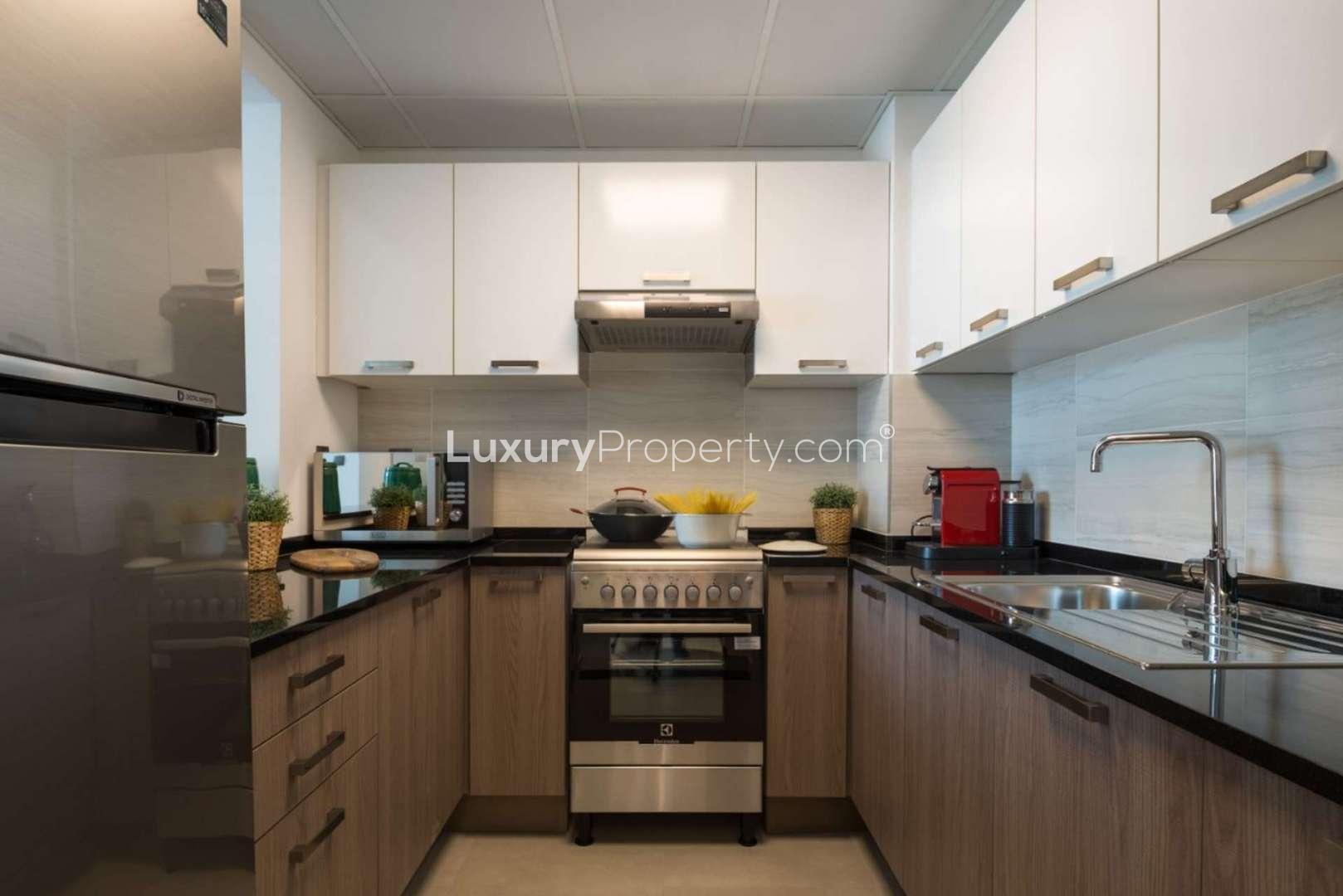 "Elegant dining area and kitchen in La Riviera, Jumeirah Village Circle apartment for sale.",Modern kitchen in luxurious La Riviera apartment, Jumeirah Village Circle, with sleek cabinetry