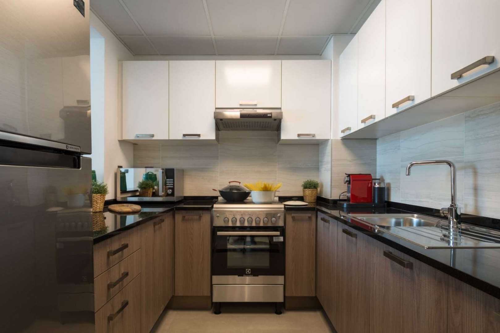 "Elegant dining area and kitchen in La Riviera, Jumeirah Village Circle apartment for sale.",Modern kitchen in luxurious La Riviera apartment, Jumeirah Village Circle, with sleek cabinetry