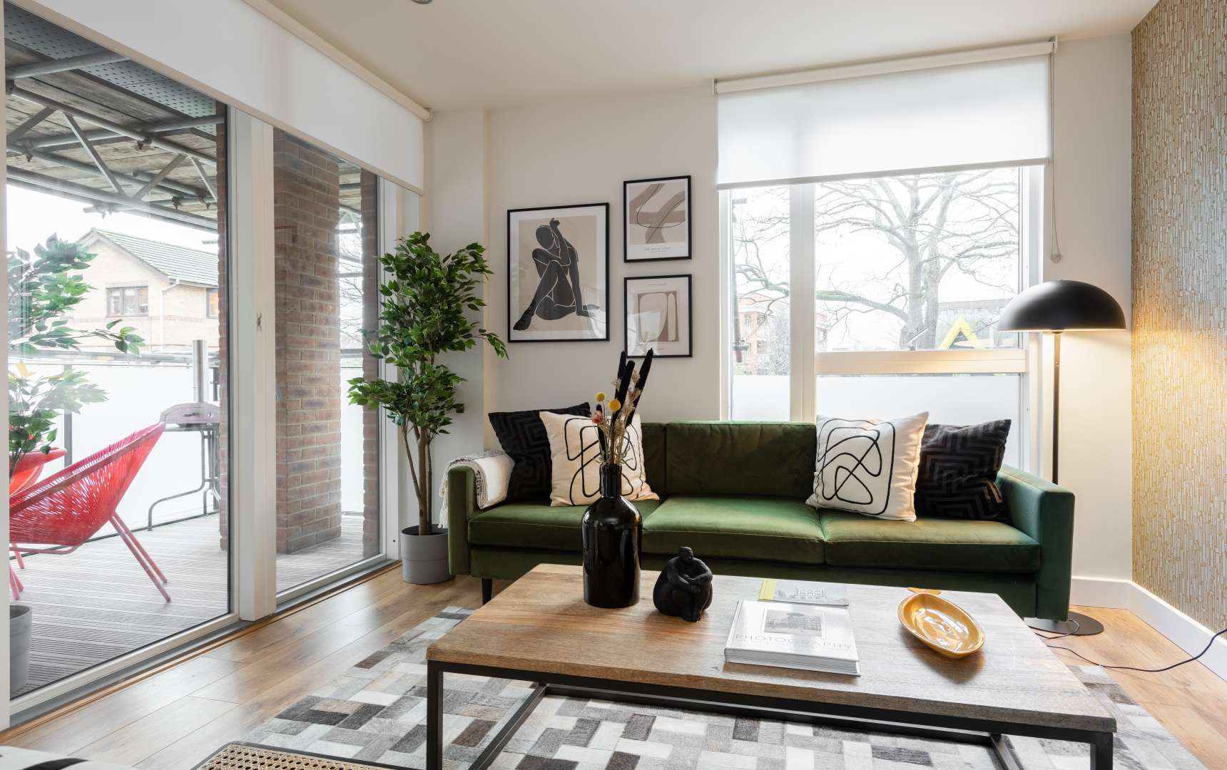 Stylish living room in two-bedroom Wharf Mill apartment, Hoxton, with modern decor and balcony