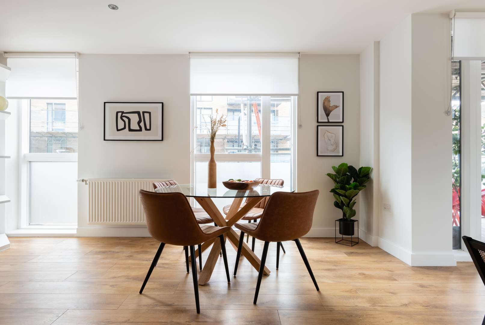 "Modern living room in two-bedroom apartment, Wharf Mill, Hoxton, with balcony view.",Dining area in modern two-bedroom apartment, Wharf Mill, Hoxton, London