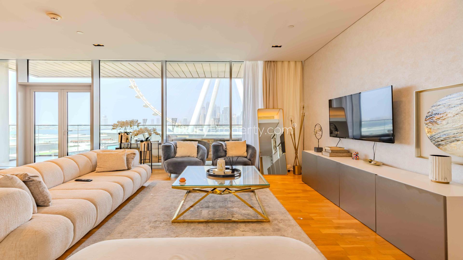 Furnished living room in sea-facing Bluewaters apartment for sale, modern decor, natural light