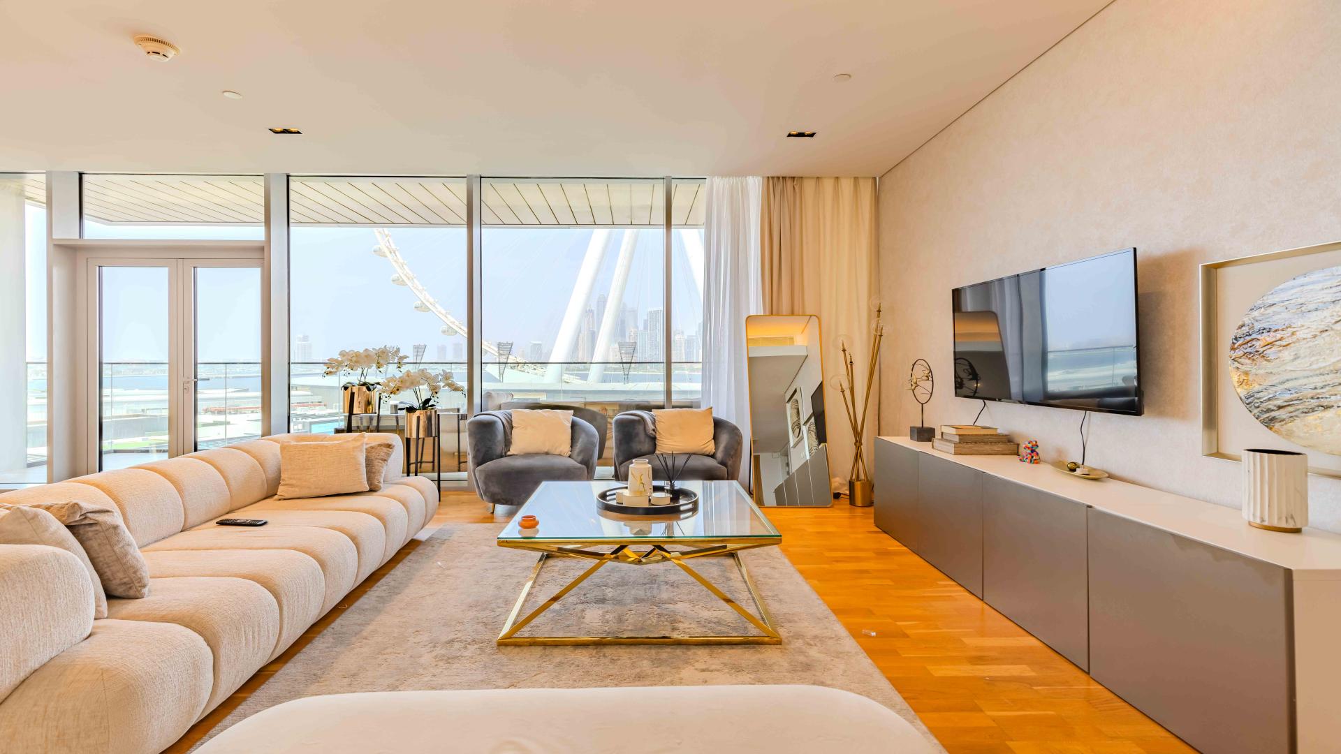 Furnished living room in sea-facing Bluewaters apartment for sale, modern decor, natural light