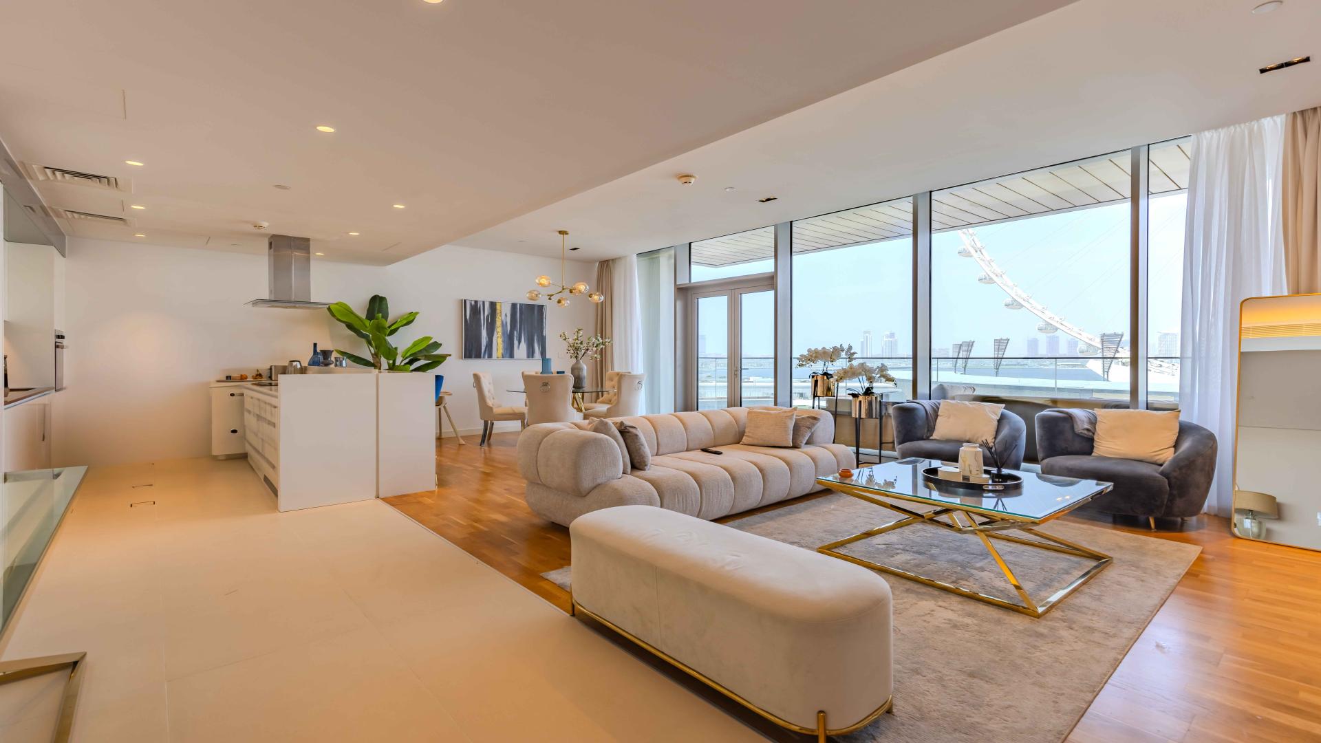 Furnished sea-facing apartment balcony view in Bluewaters Residences, overlooking skyline and Ferris wheel