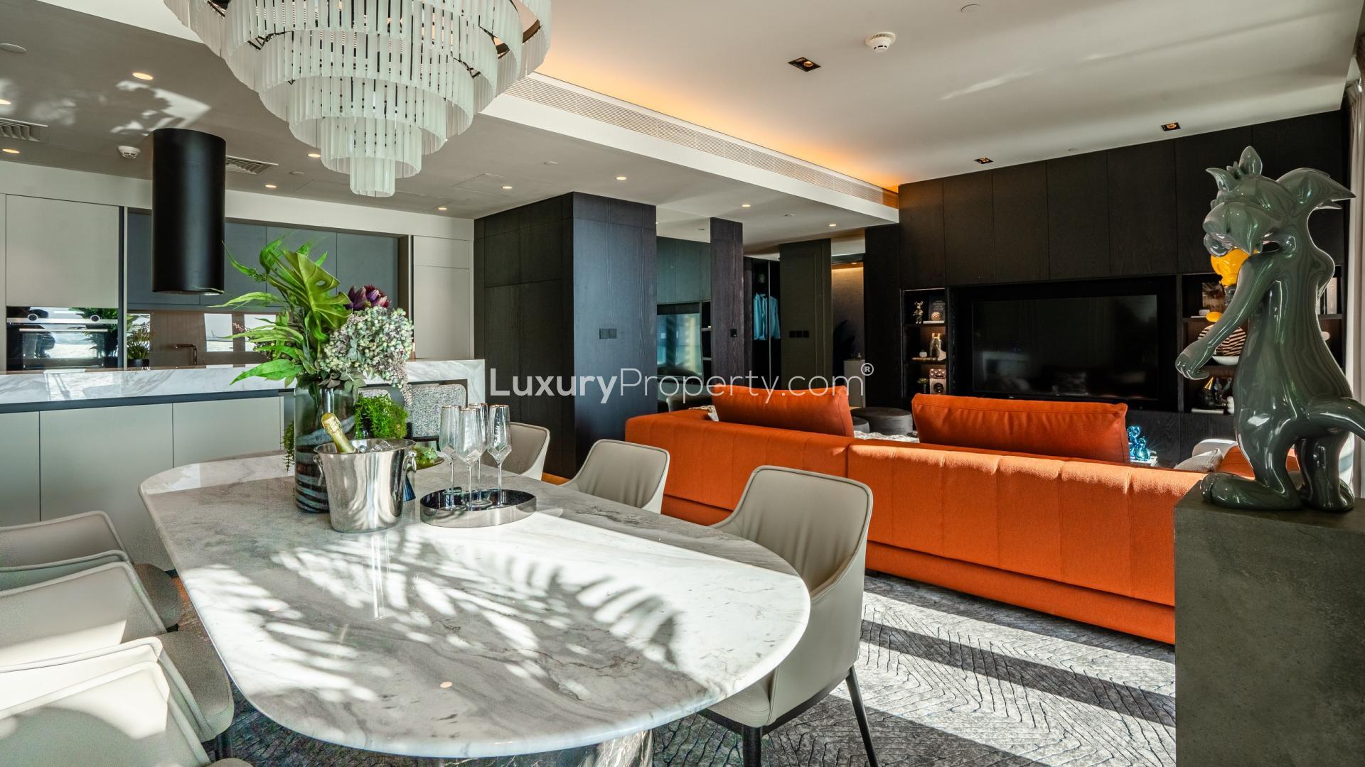 Balcony view from Bluewaters Residences apartment, featuring ocean scenery and lush greenery